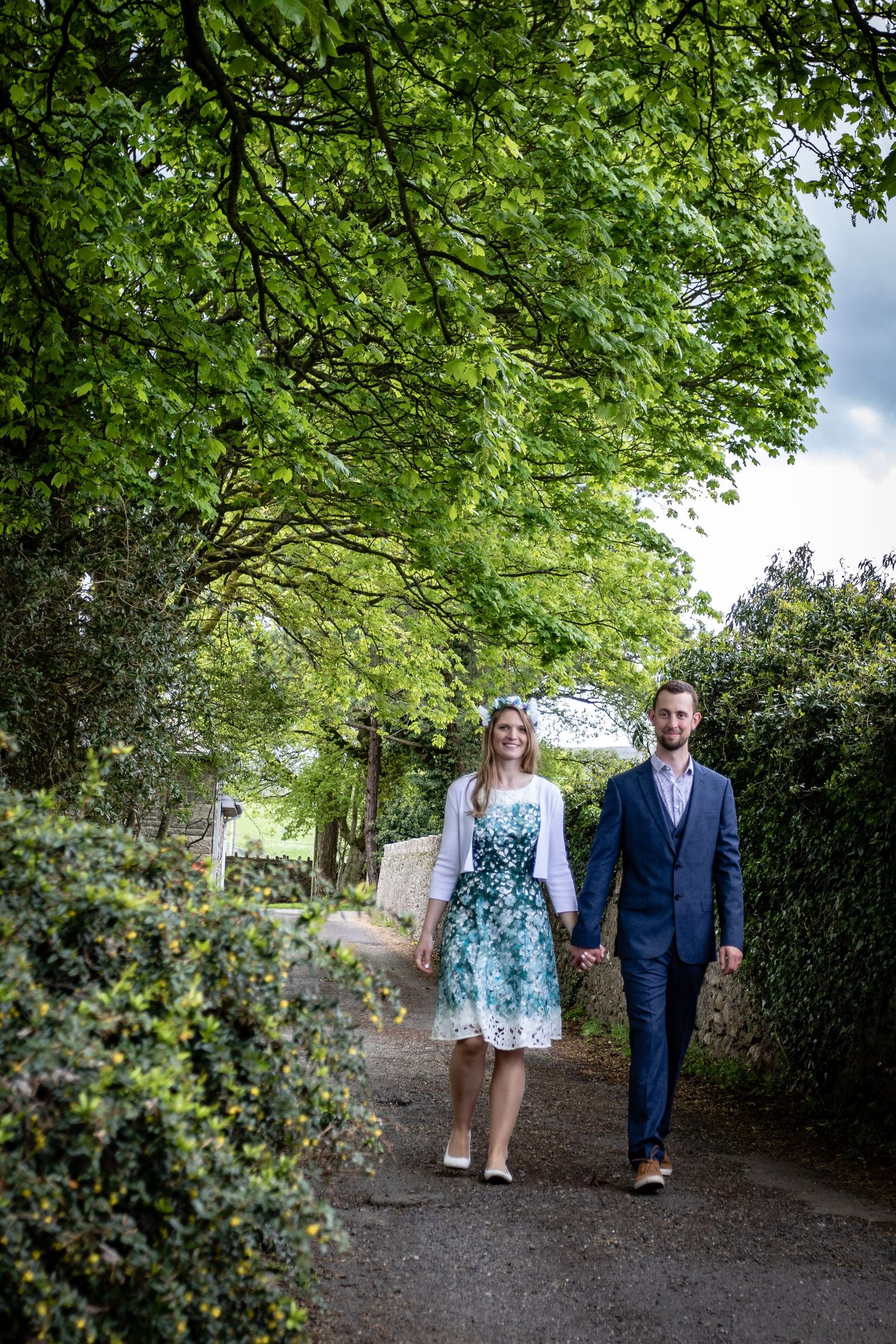 Romantic couple walking through a scenic countryside path in North Yorkshire