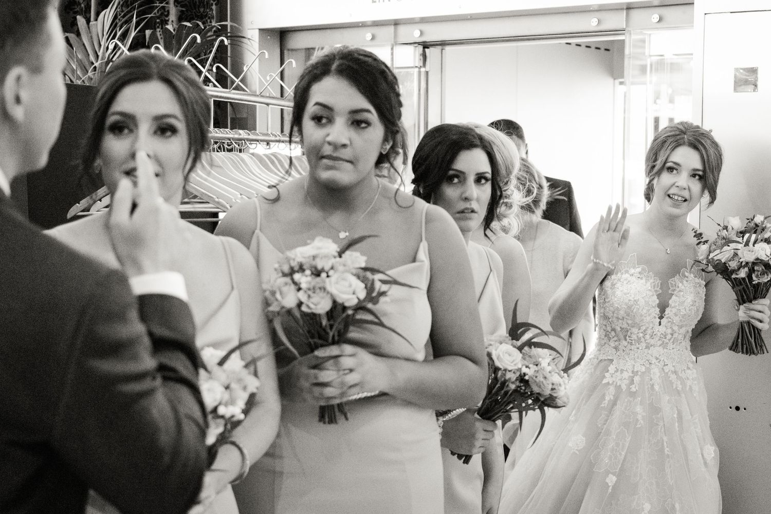Bride greets guests with bridesmaids at Baltic Newcastle, candid wedding moment capturing emotion and style in North East UK venue