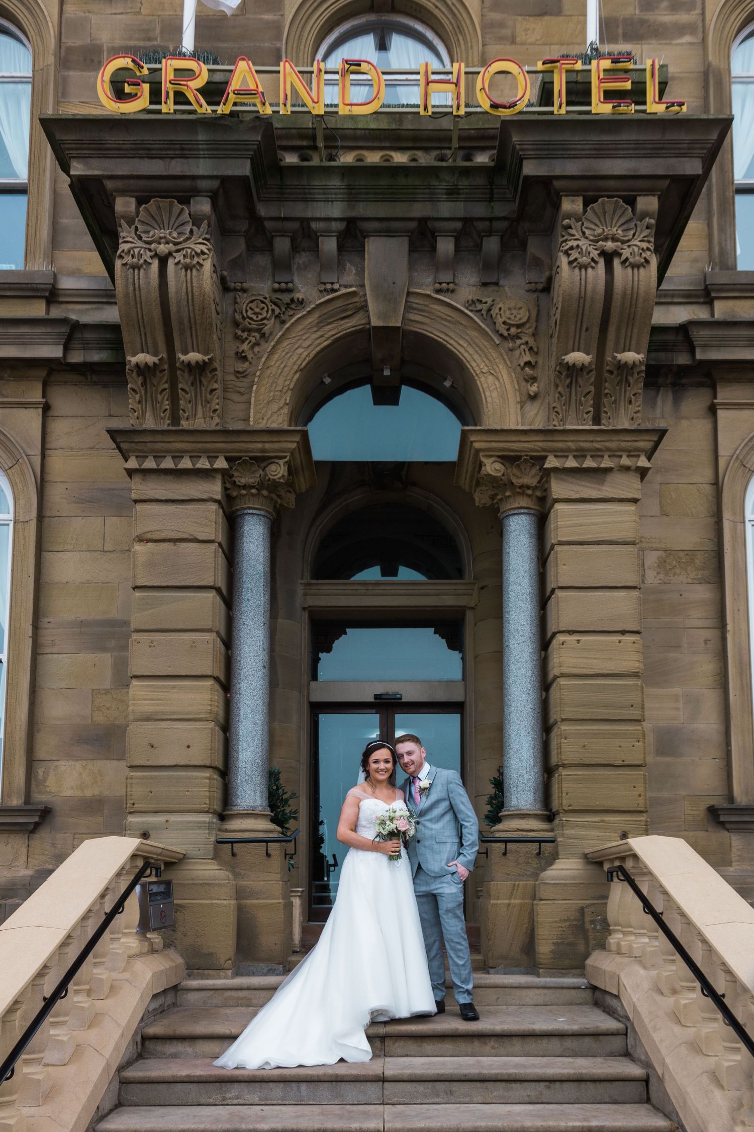Elegant wedding couple portrait on the steps of the Grand Hotel Tynemouth, a stunning North East seaside wedding venue