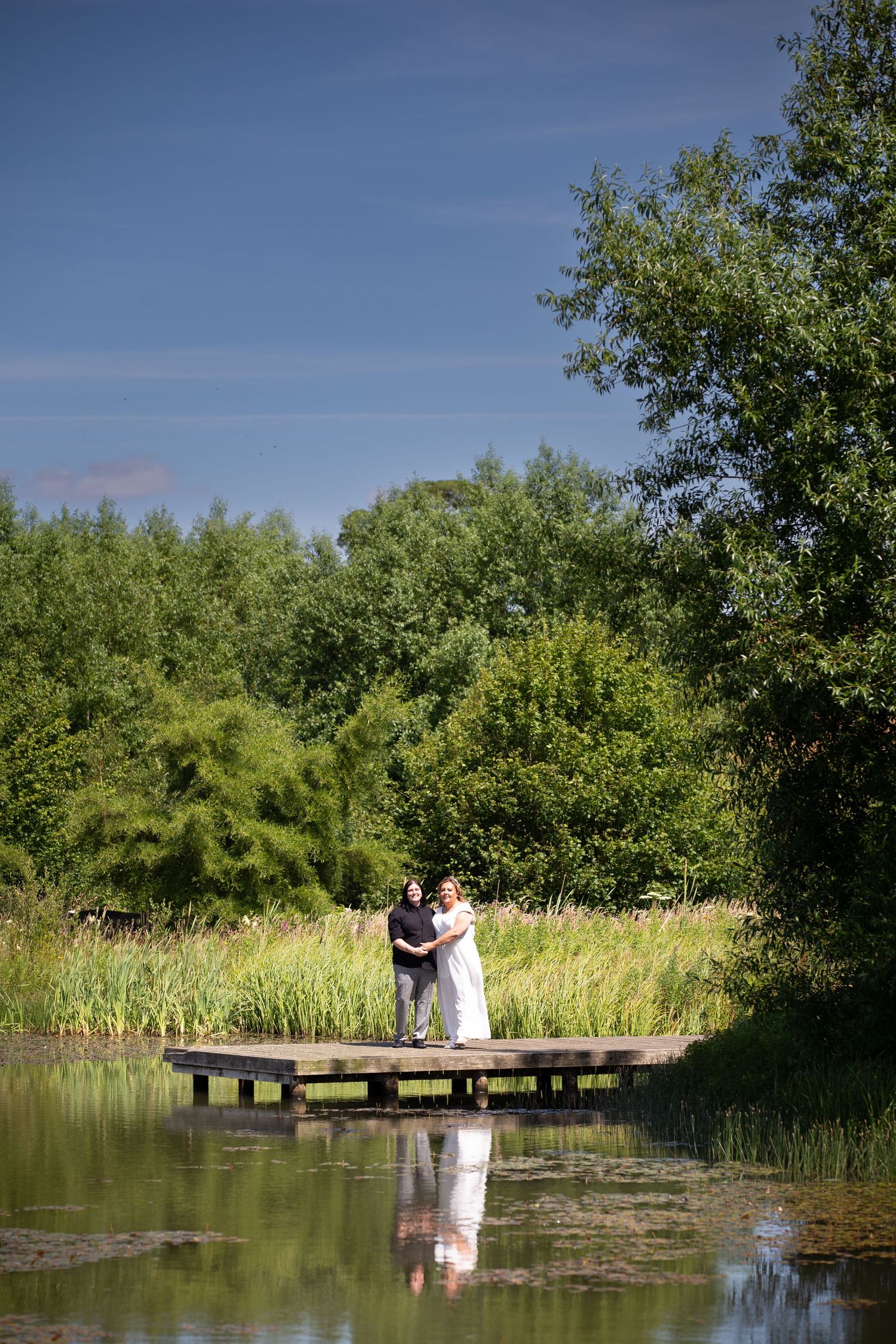 Same-sex couple exchange vows at The Hub, Barnard Castle; heartfelt outdoor ceremony moment.