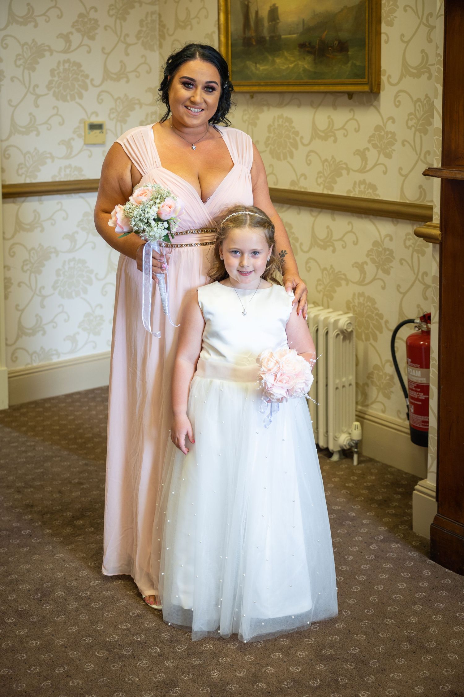 Bridesmaid and flower girl pose beautifully at North Shields Registry Office, capturing a sweet and elegant moment before the wedding ceremo