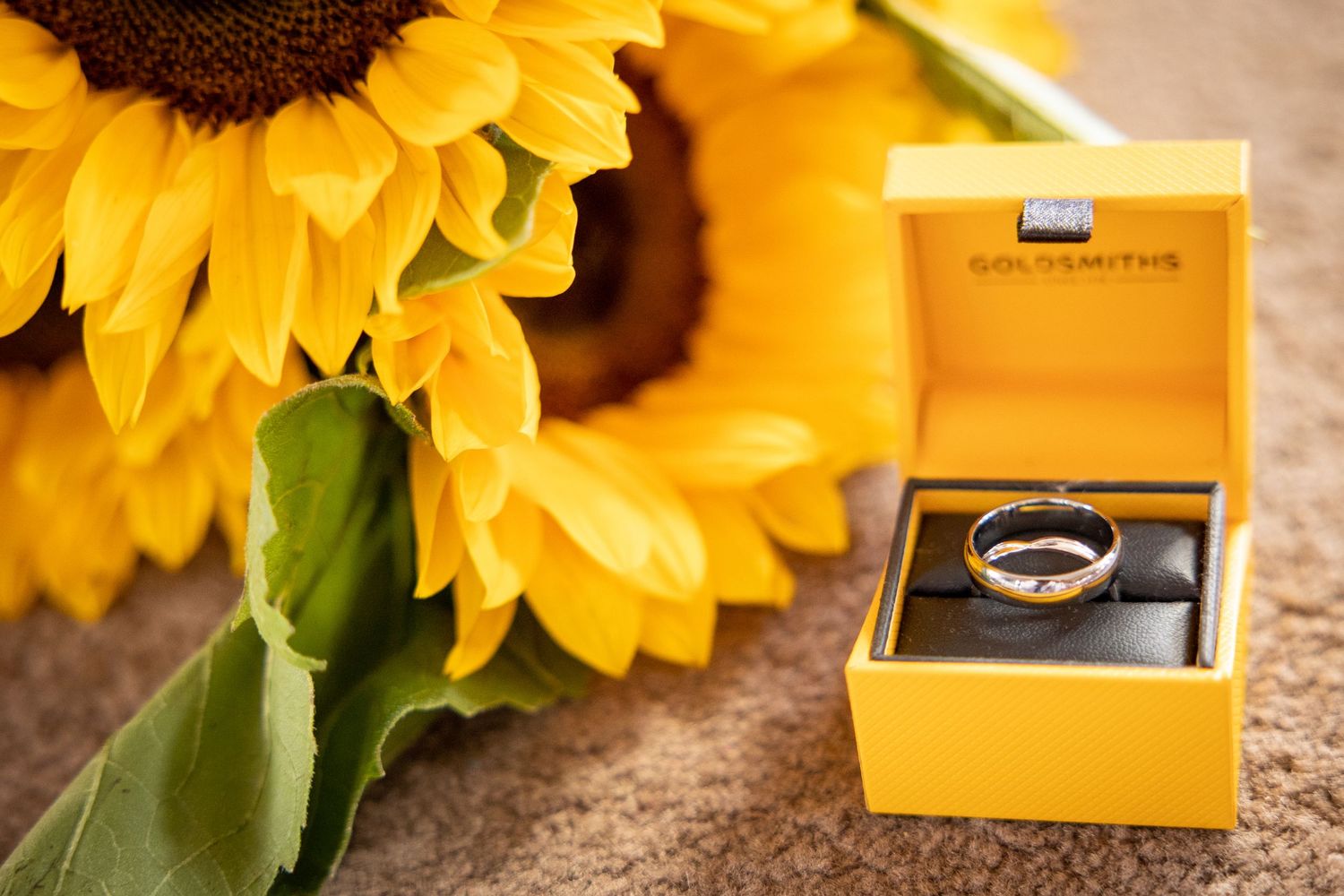 Wedding ring in gold box with sunflowers, elegant summer wedding detail with bright yellow flowers and romantic styling