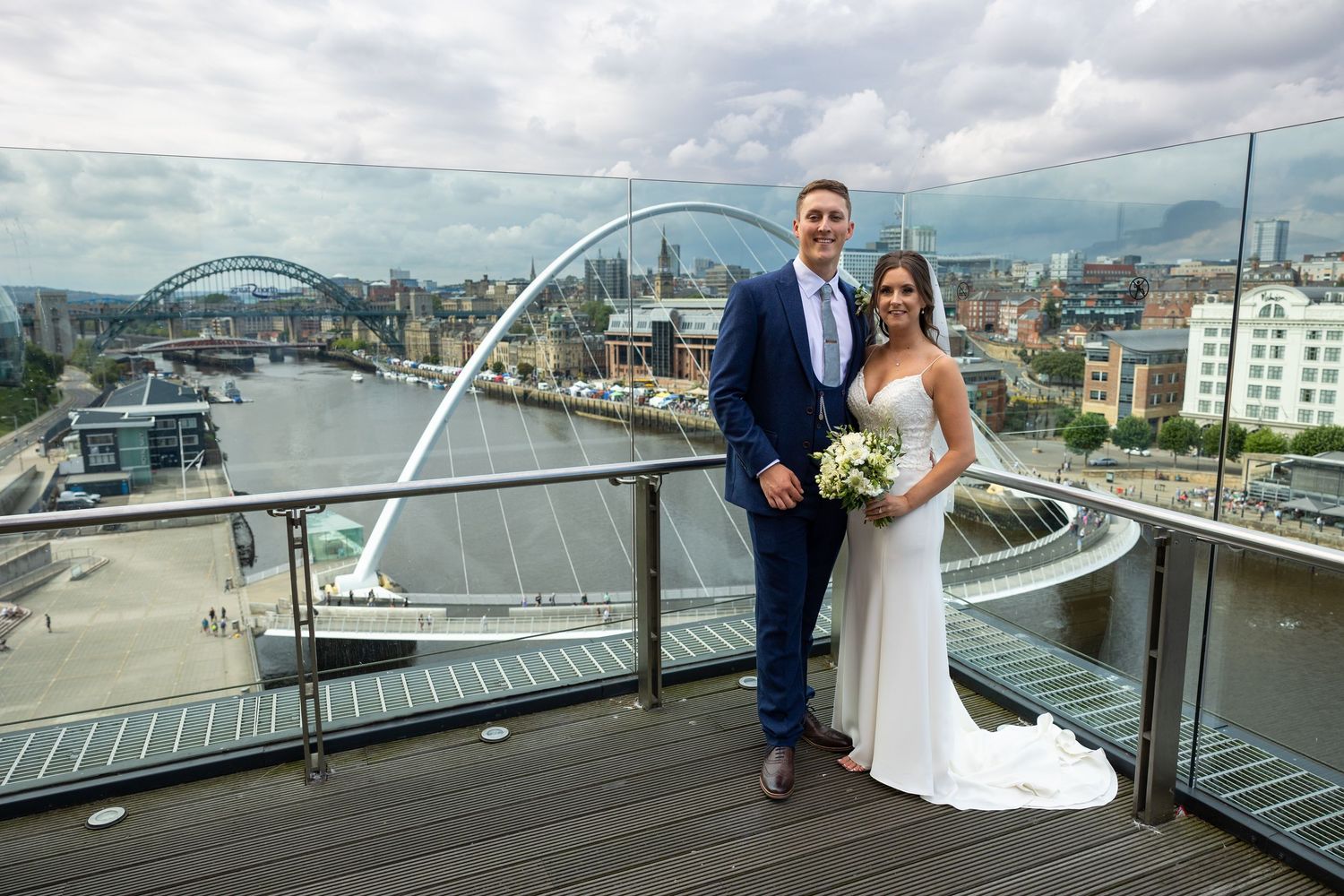 Bride and groom wedding at BALTIC Centre for Contemporary Art with Millennium Bridge and River Tyne skyline backdrop, modern city venue port