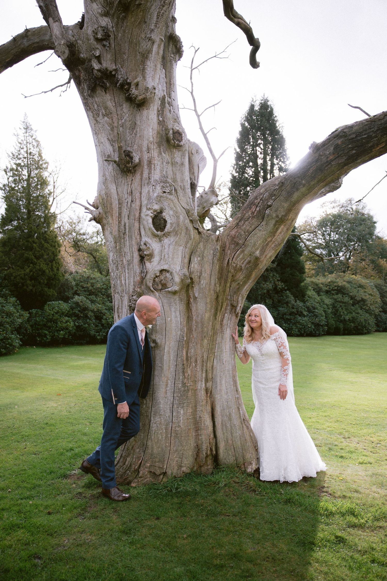 Bride and groom by ancient tree at Beamish Hall Hotel, romantic outdoor wedding portrait in scenic countryside grounds