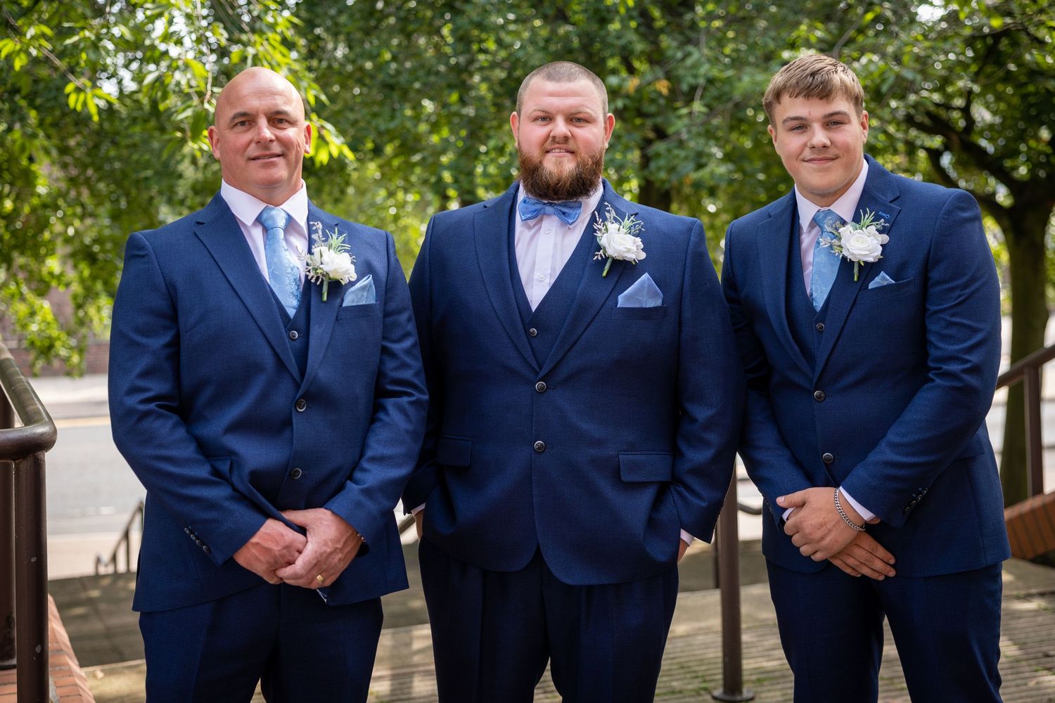 Three groomsmen pose outside Gateshead Registry Office; smart blue suits and relaxed smiles.