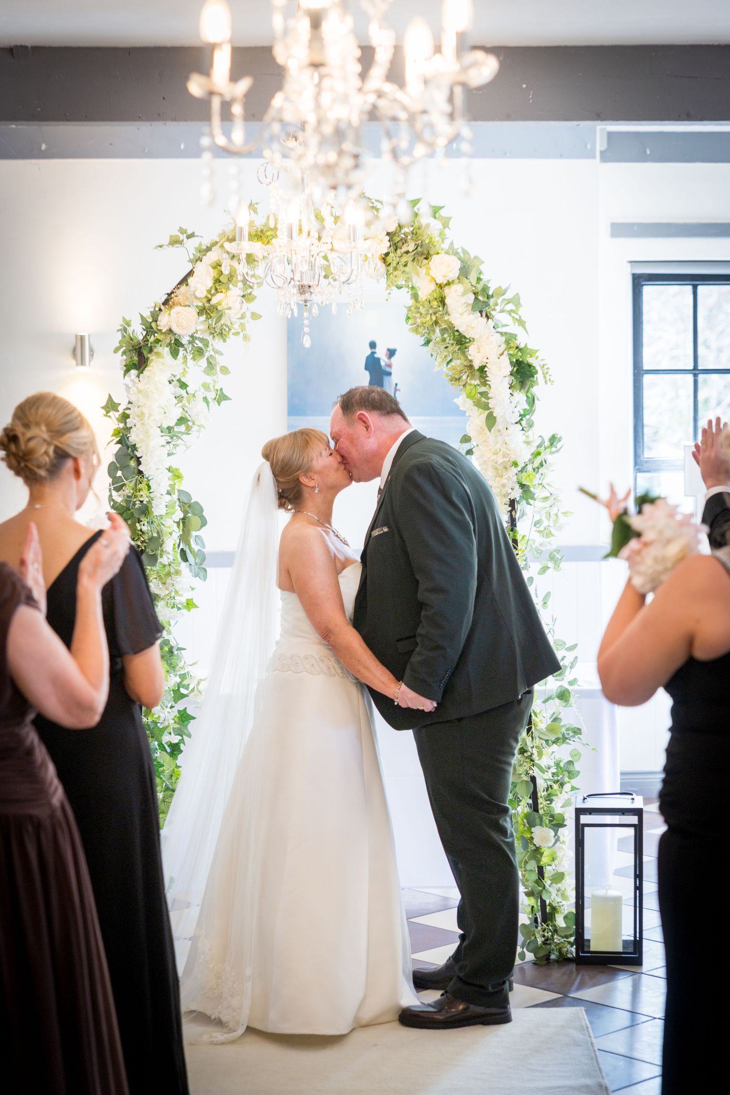 First kiss at The Ropery, Sunderland; couple under floral arch as guests applaud.