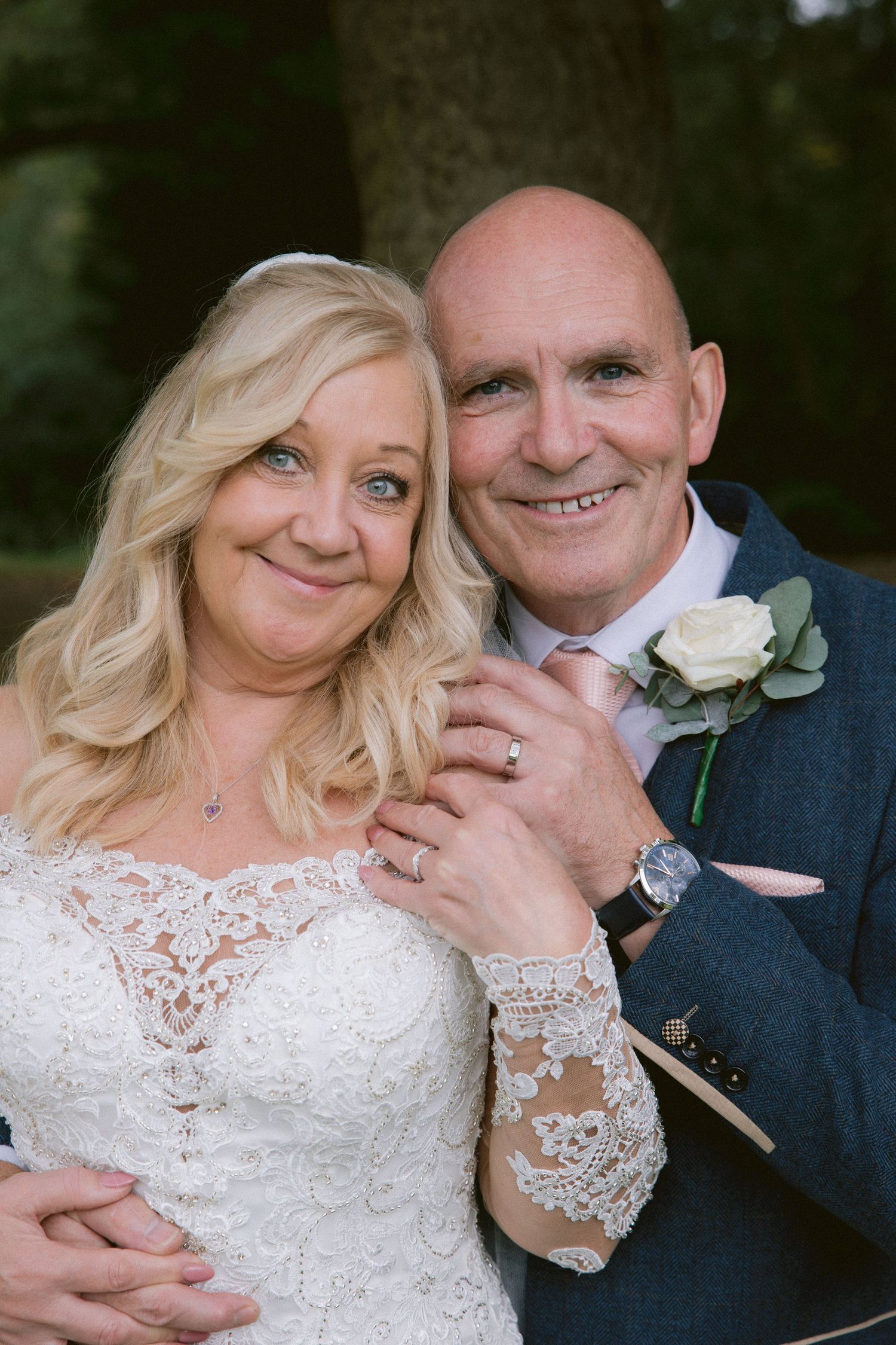 Close-up of couple at Beamish Hall; warm, natural portrait with soft greenery backdrop.