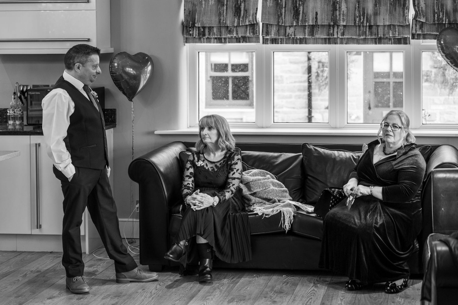 Groom chats with guests before ceremony, candid wedding moment Black Horse Hotel North east