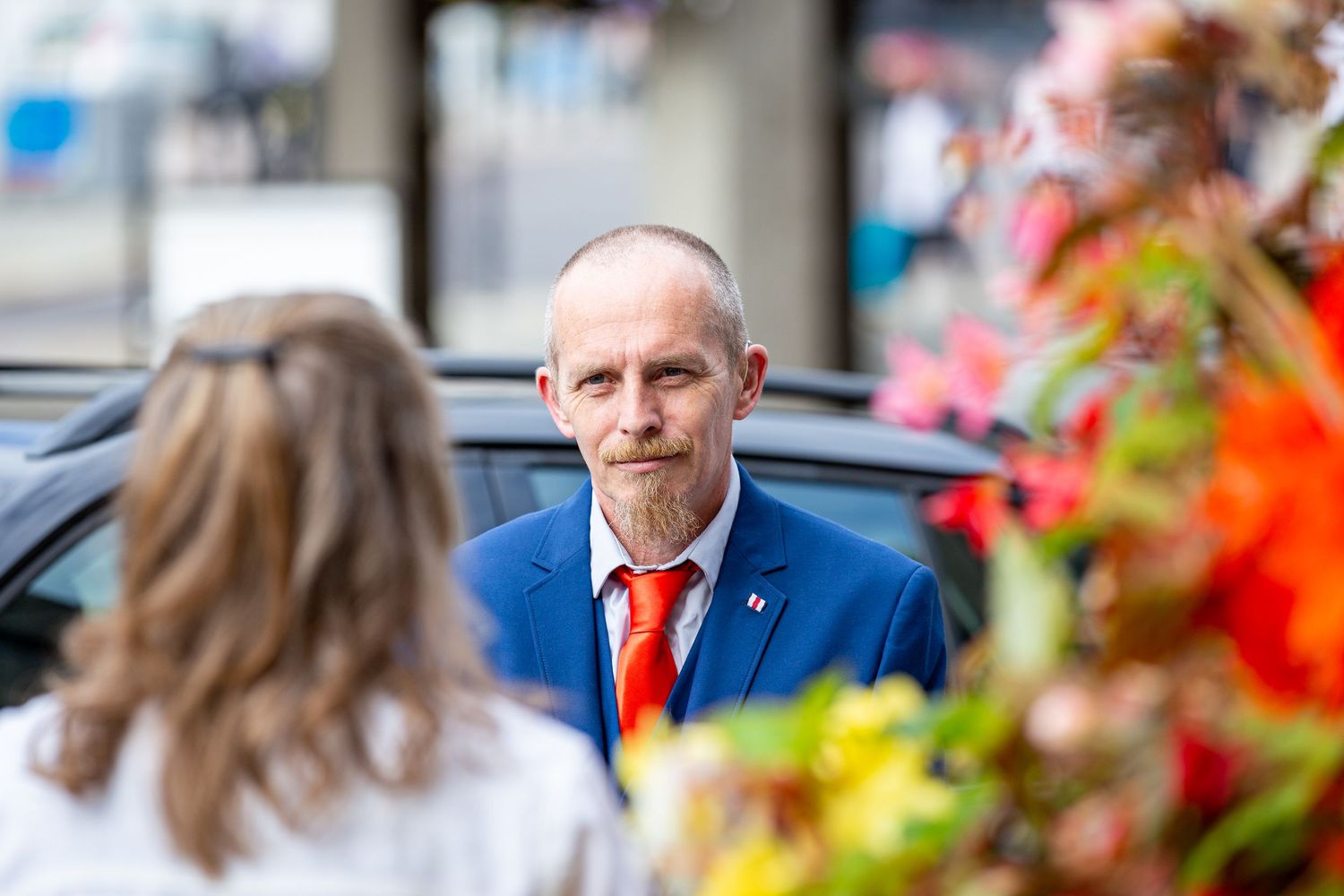 Wedding guest waits outside Darlington Registration Office, capturing a natural, emotional moment full of anticipation before the ceremony.
