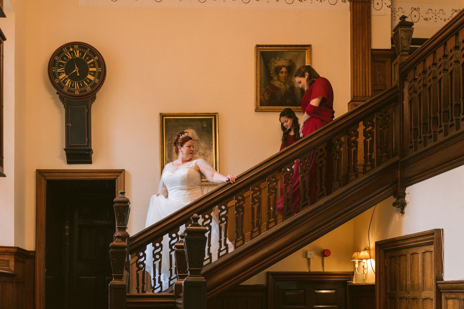 Bride walks down staircase at Ramside Hall, elegant North East UK wedding venue with classic interiors and timeless romantic atmosphere