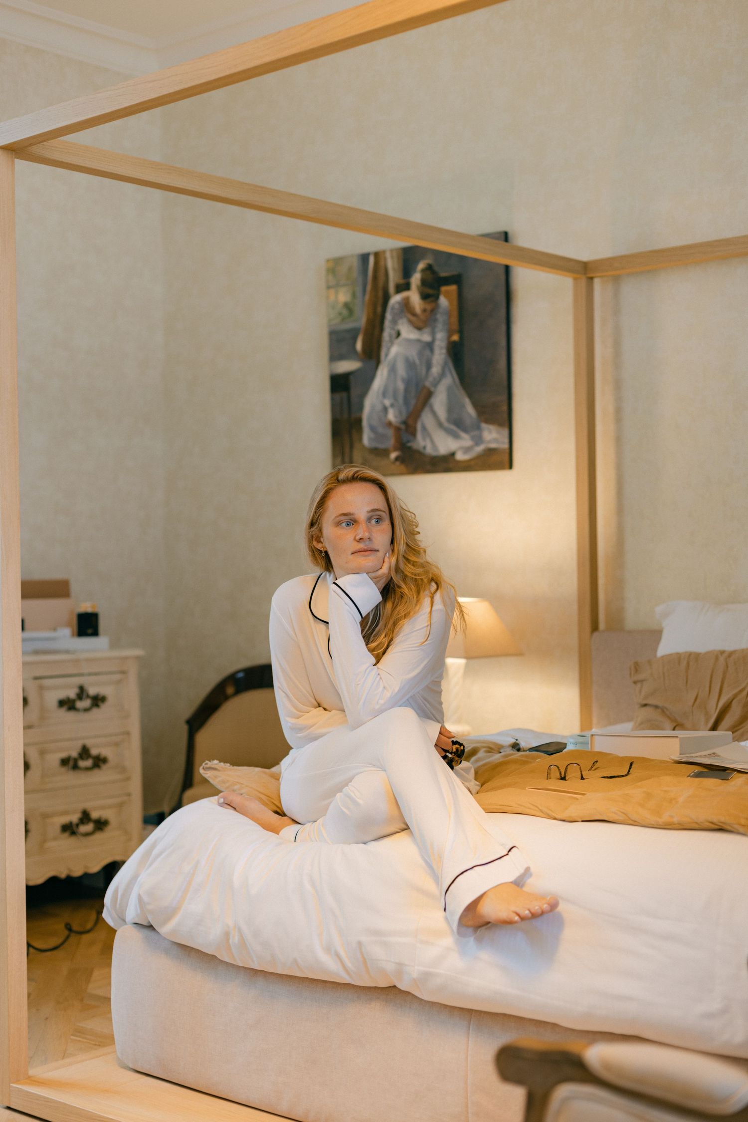 Relaxing morning scene in bright white hotel room with comfortable bedding.