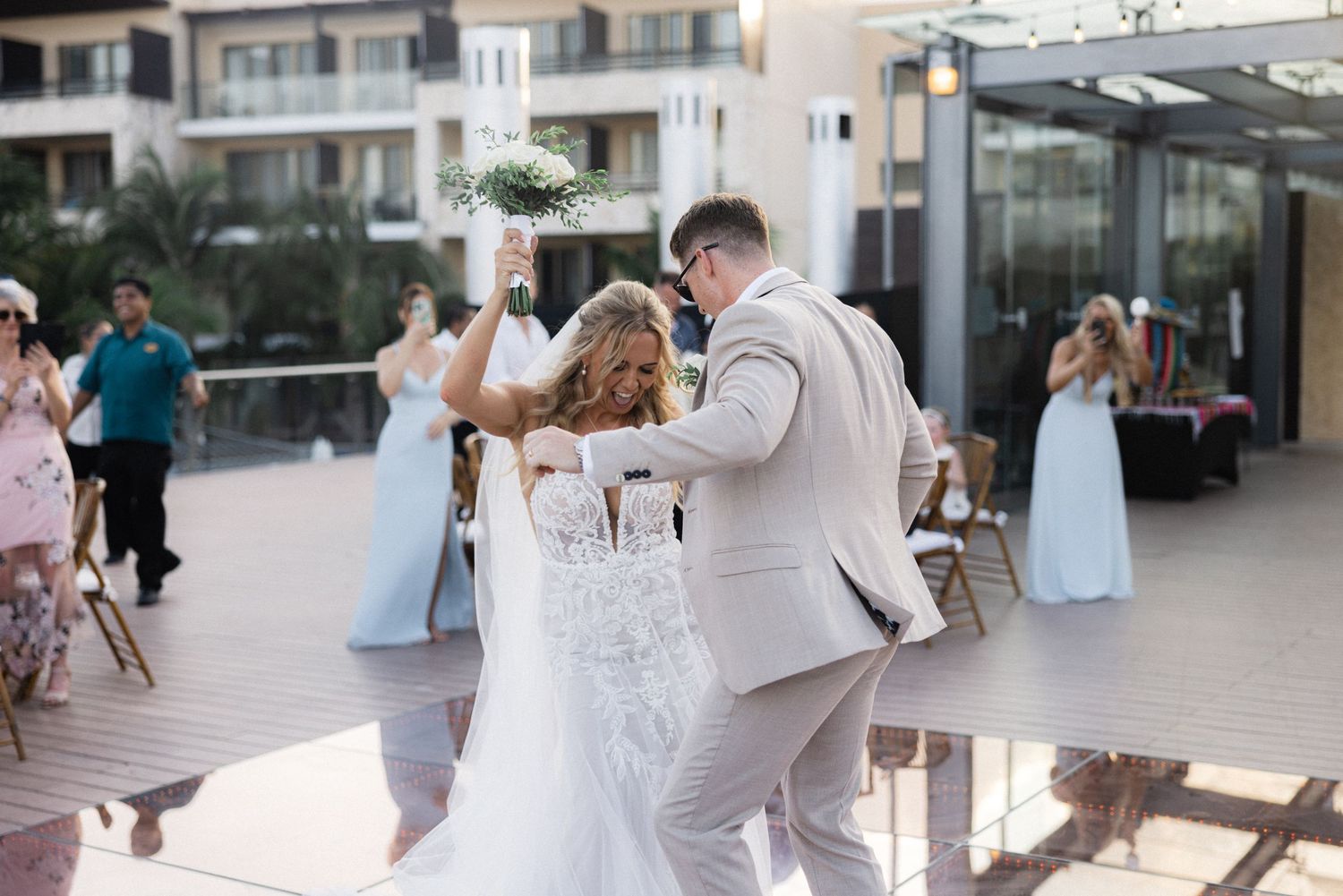 Wedding celebration dance sequence at an outdoor terrace venue.