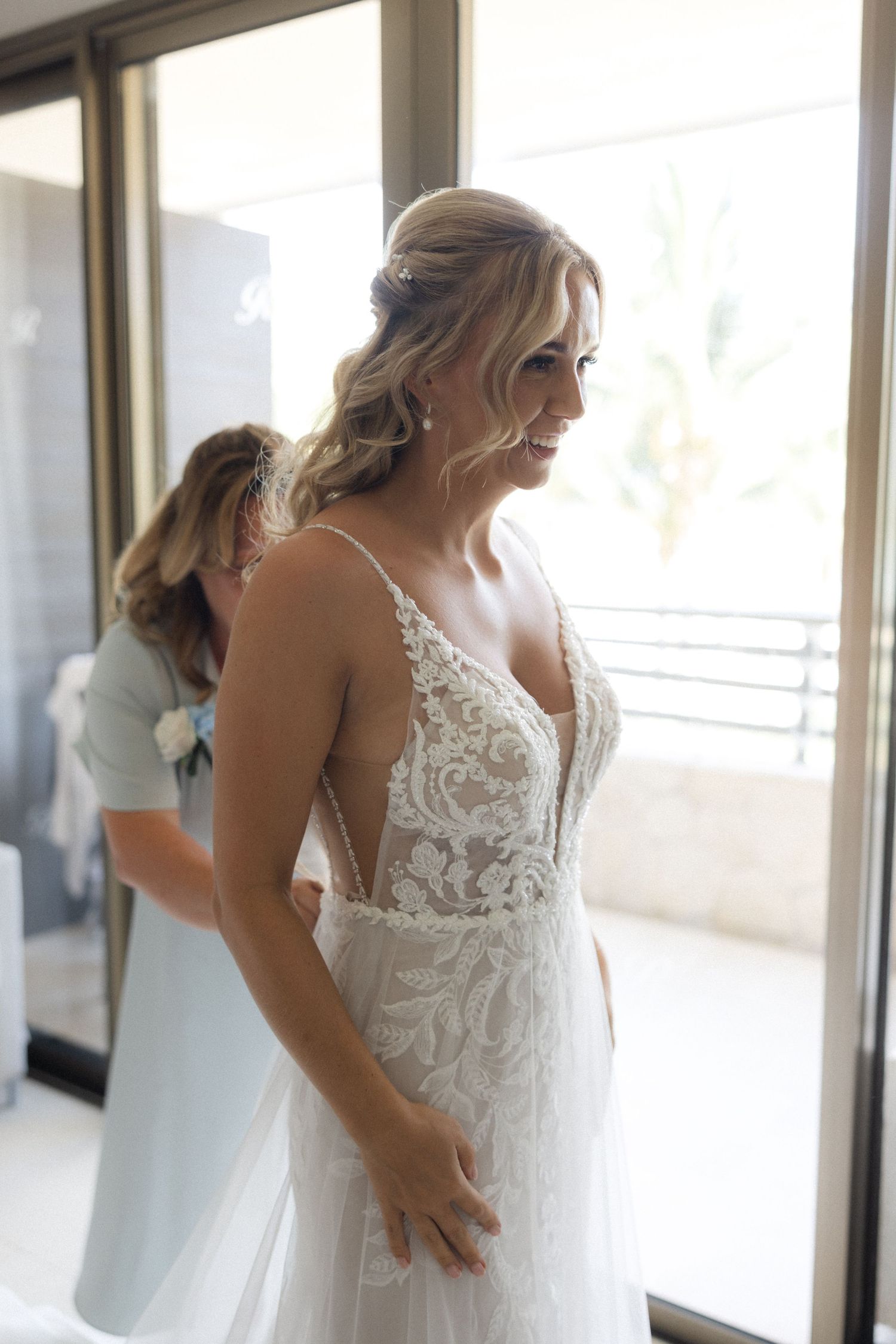 Beautiful lace wedding dress with plunging neckline and intricate details.