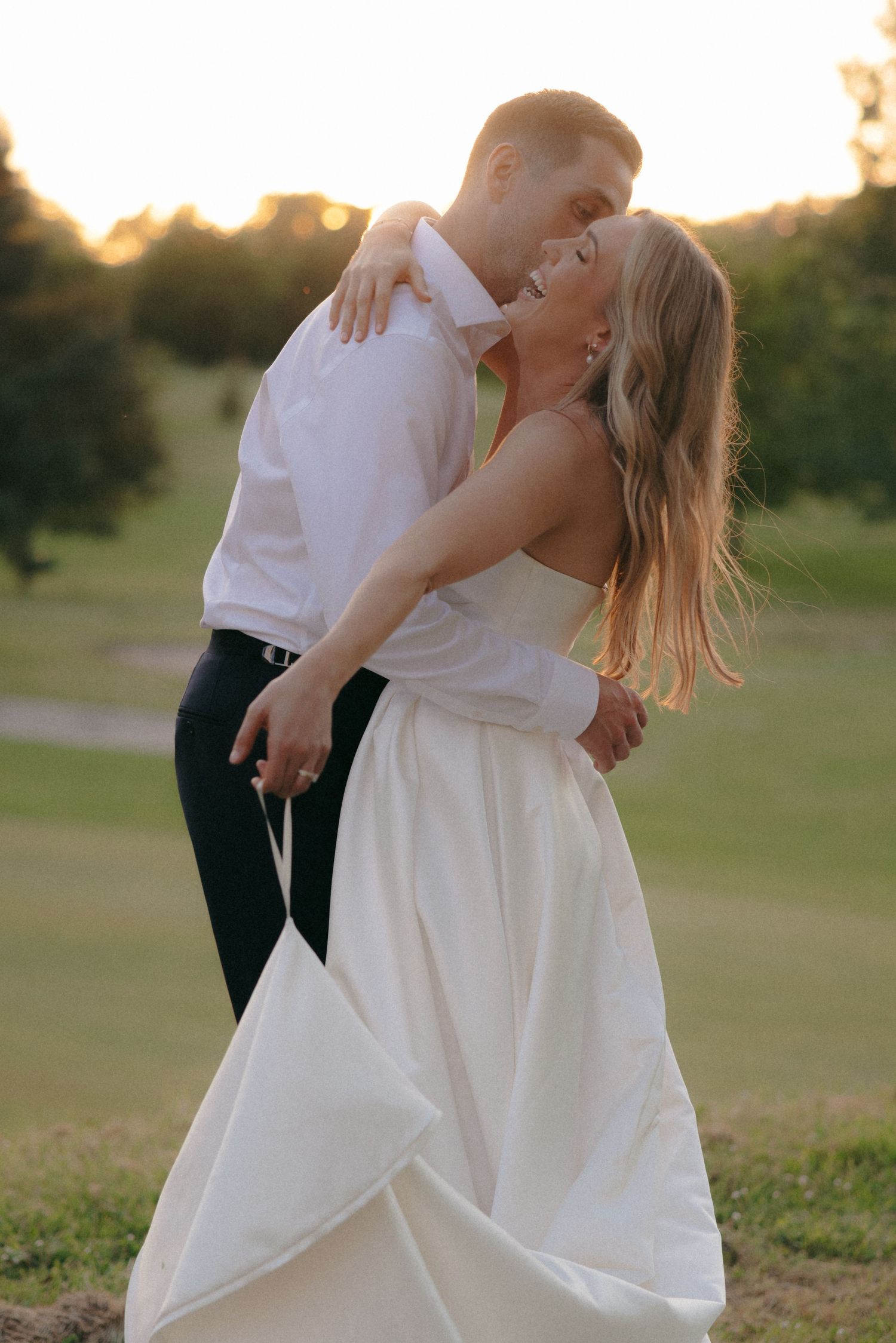 Romantic dance sequence of newlyweds in a golden-hour lit field.