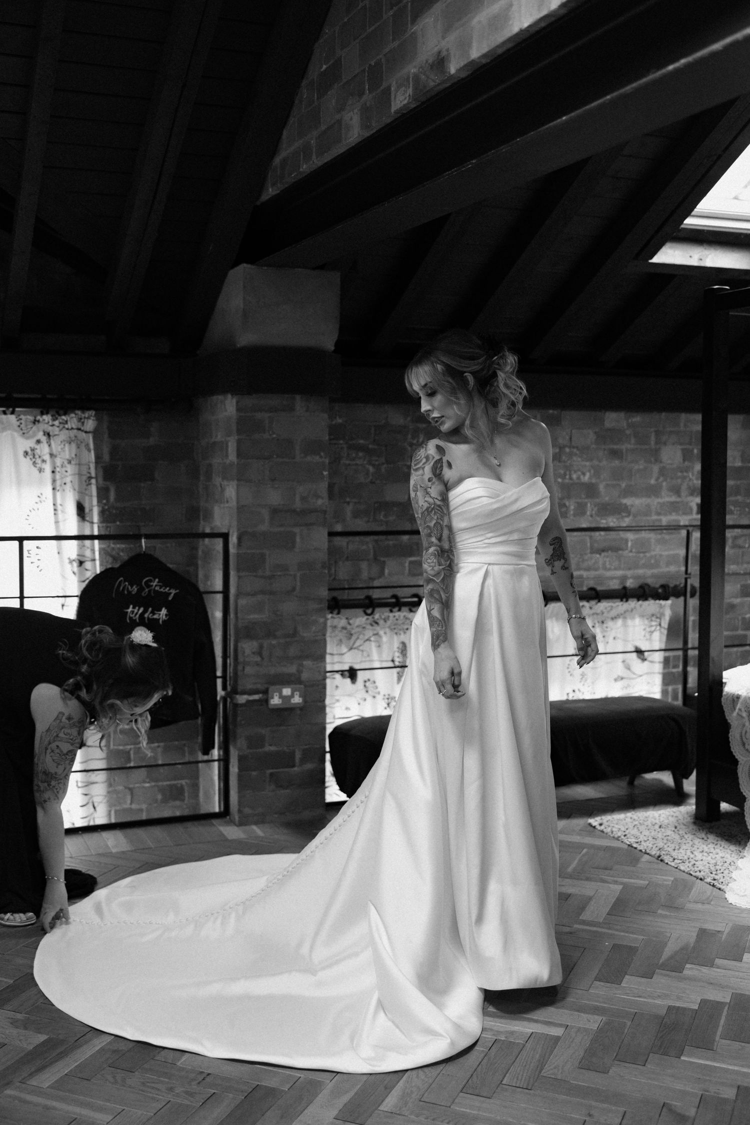 Black and white photos of a wedding dress train flowing across a herringbone floor.