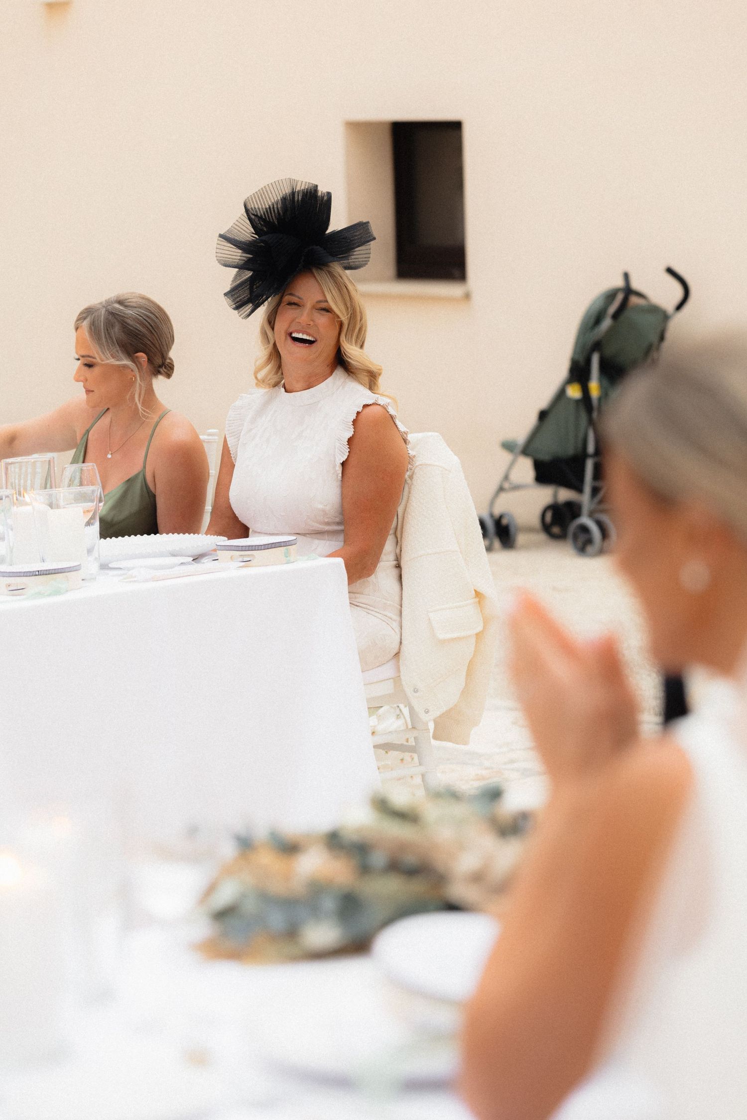 Candid laughter shared during wedding reception speeches at an elegant venue.