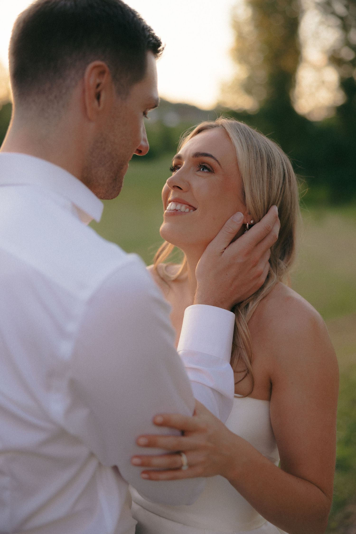Close-up romantic moments between newlyweds in warm sunset light.