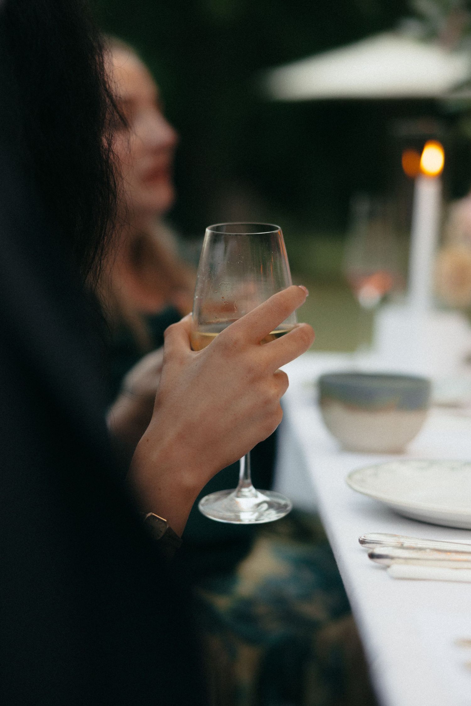 Wine glasses and place settings on an elegant wedding reception table.