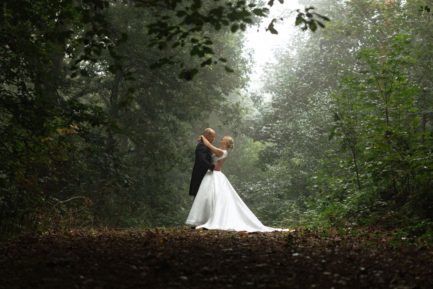 Artistic wedding photography sequence showing couple in foggy forest landscape.