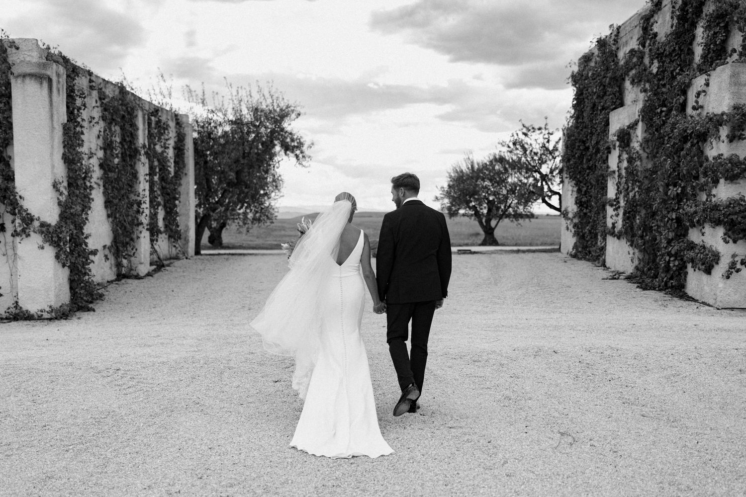 Minimalist black and white wedding photos on an outdoor path.
