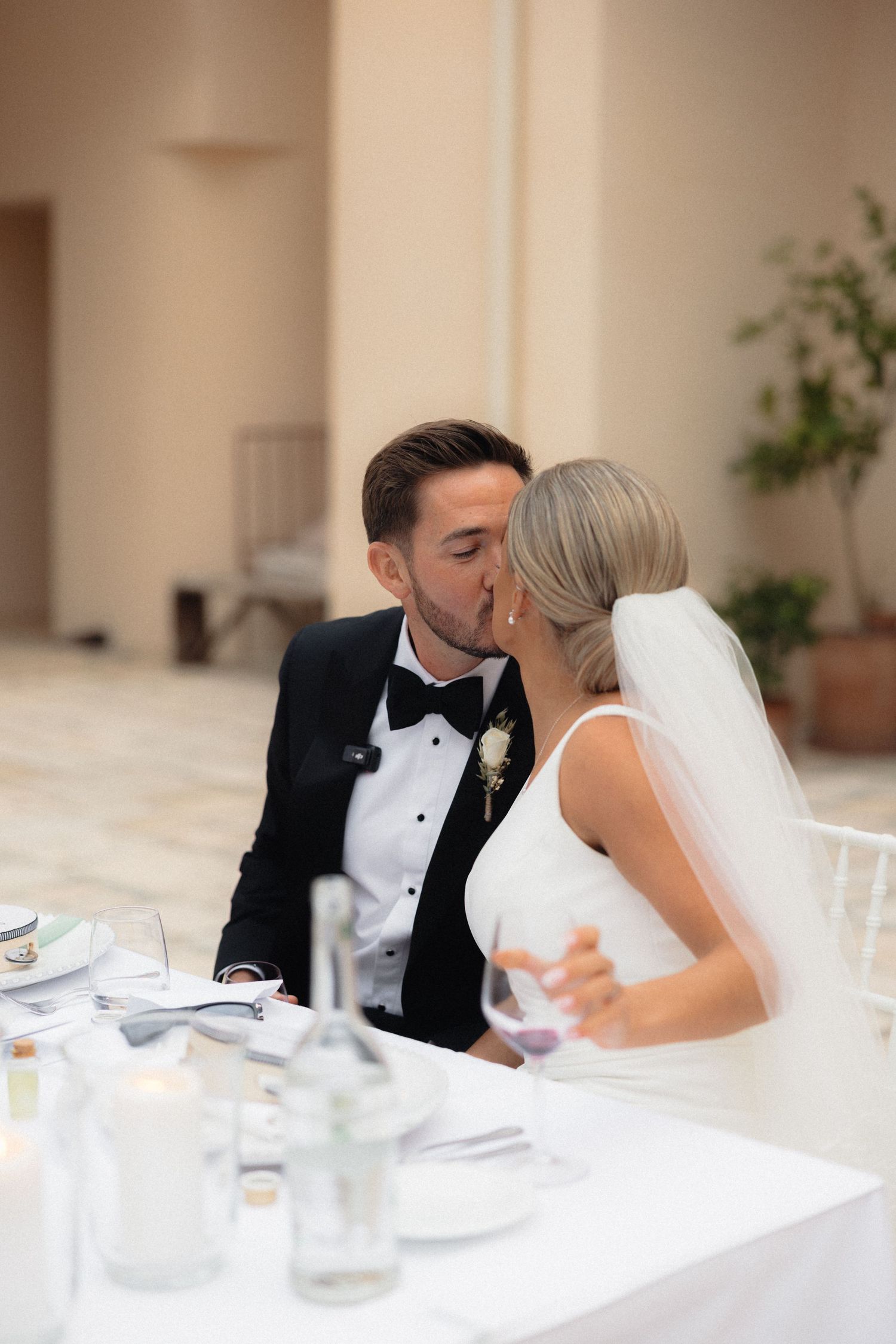 Intimate moment shared between couple during wedding reception speeches.