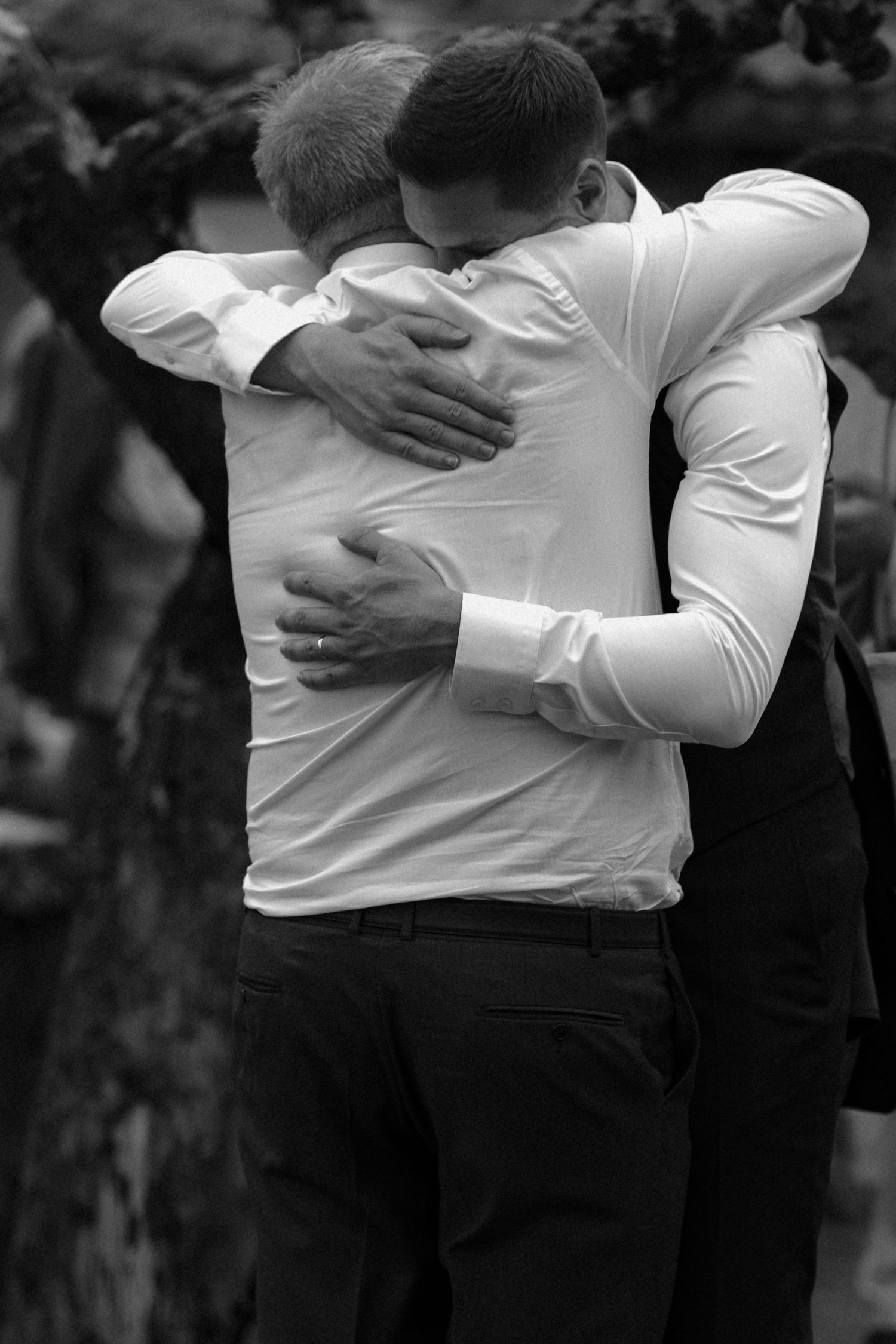 Black and white photo of two people sharing an emotional embrace.