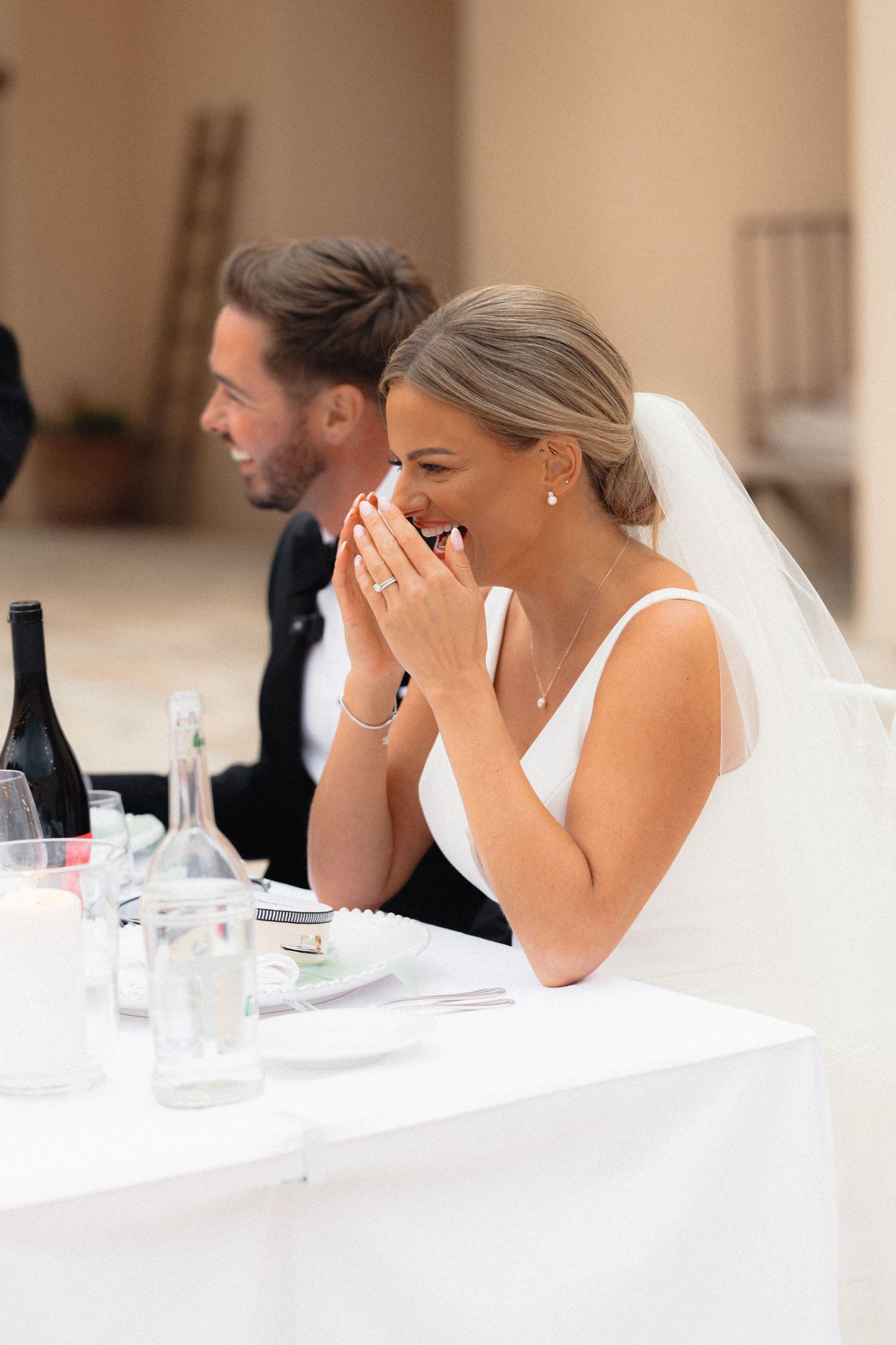 Emotional reactions during wedding speeches at an elegant reception dinner.