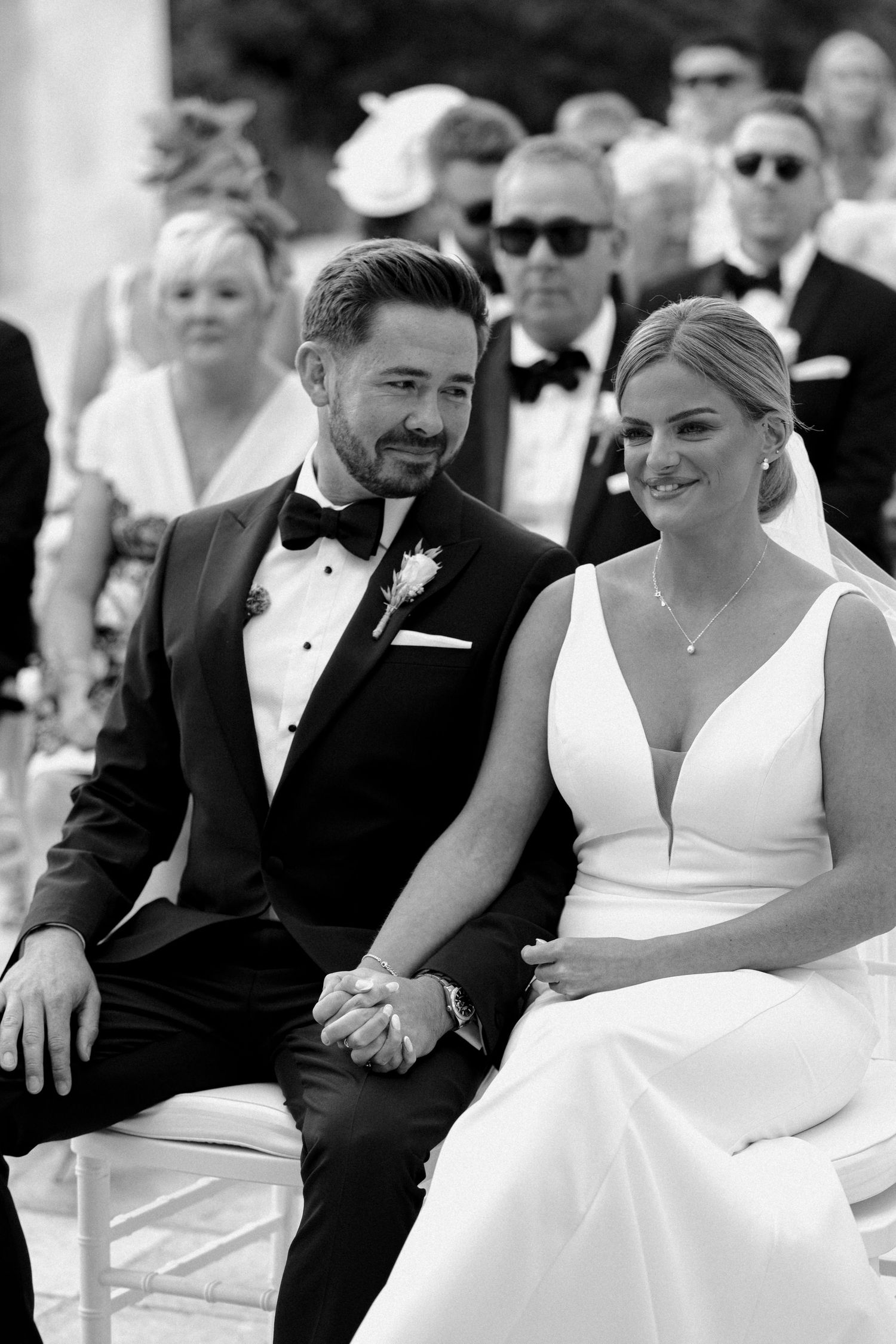 Black and white candid moments captured during a formal wedding ceremony.