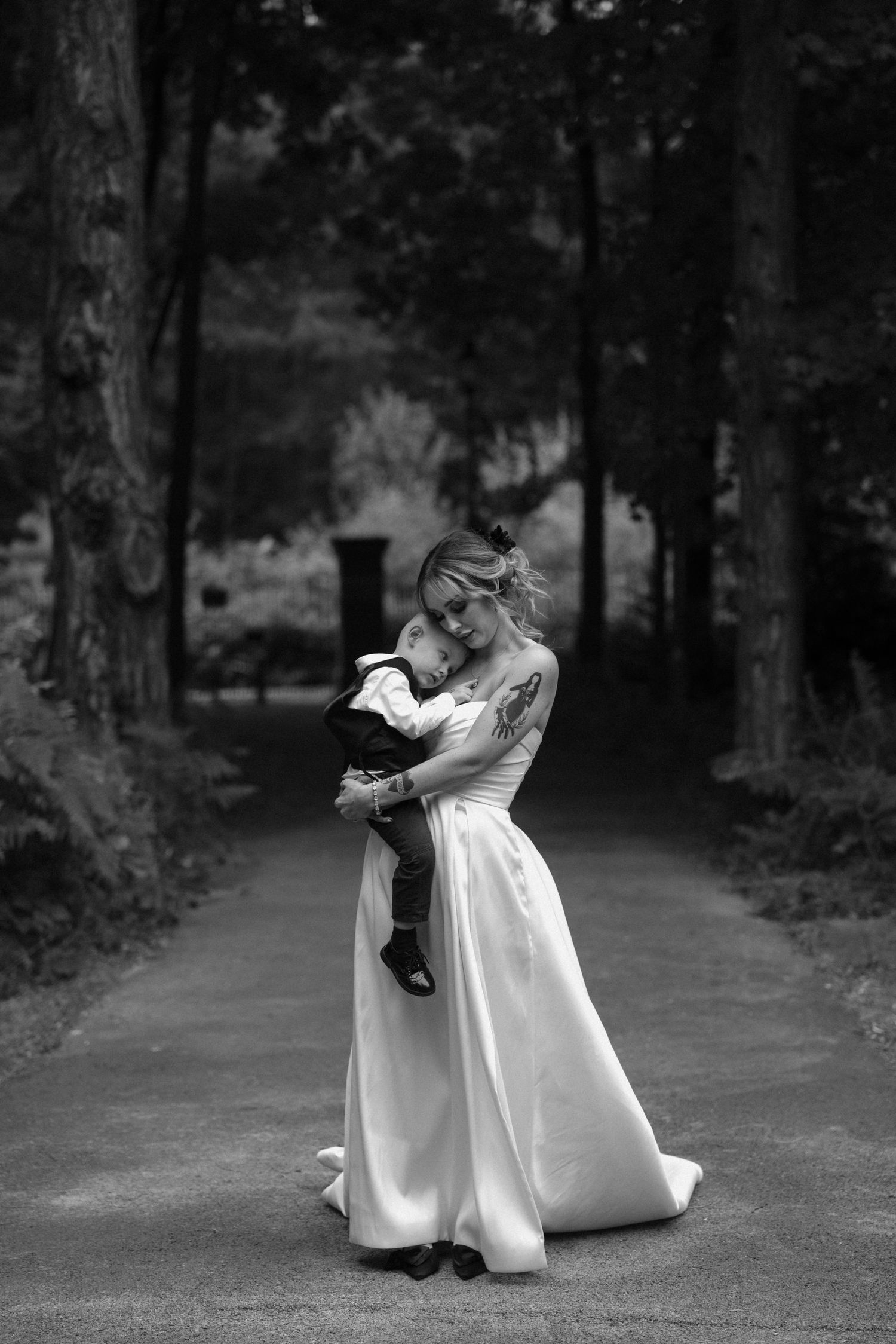 Black and white wedding dance sequence showing romantic moments on a wooded path.