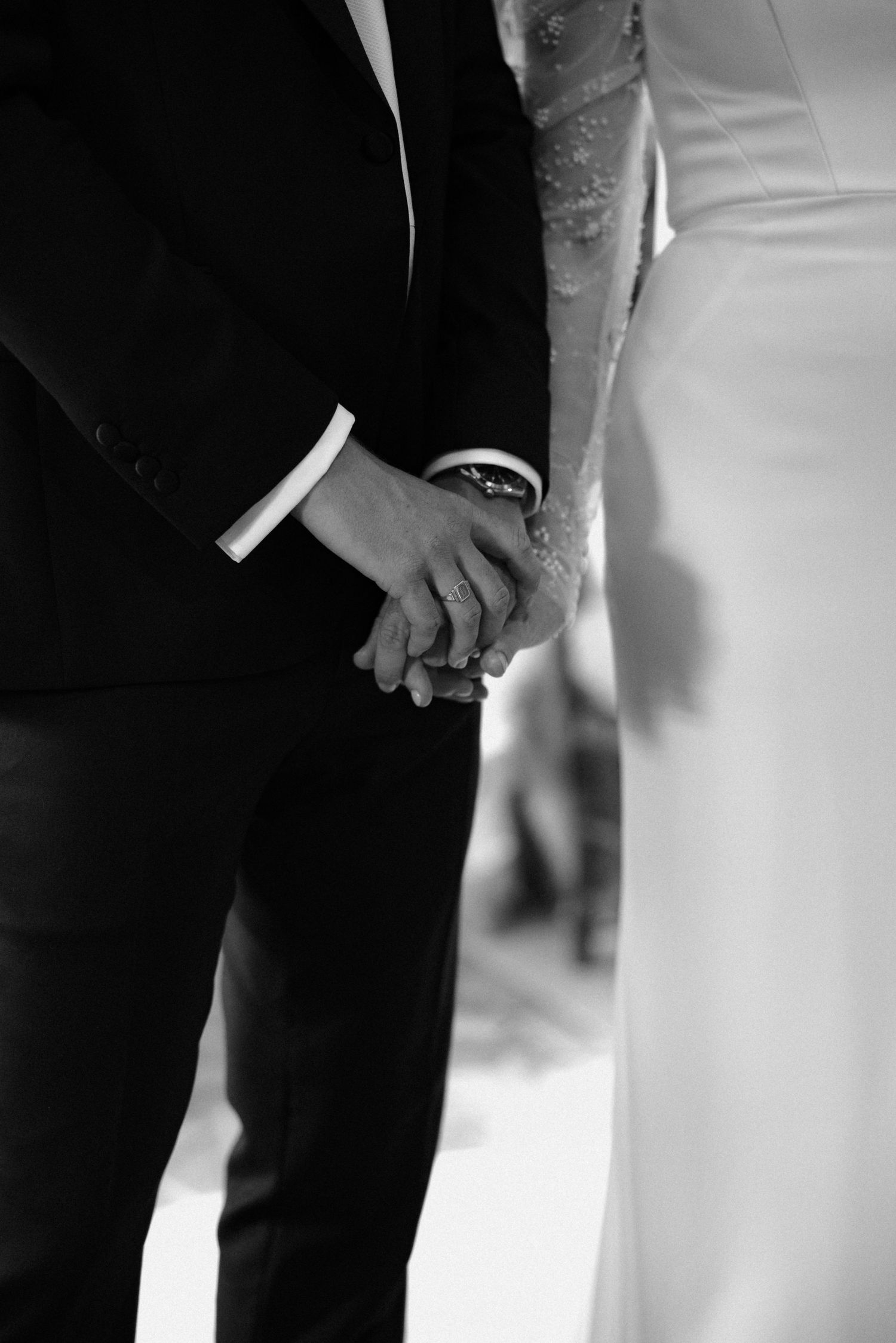 Close-up detail shot of formal wedding attire in black and white.