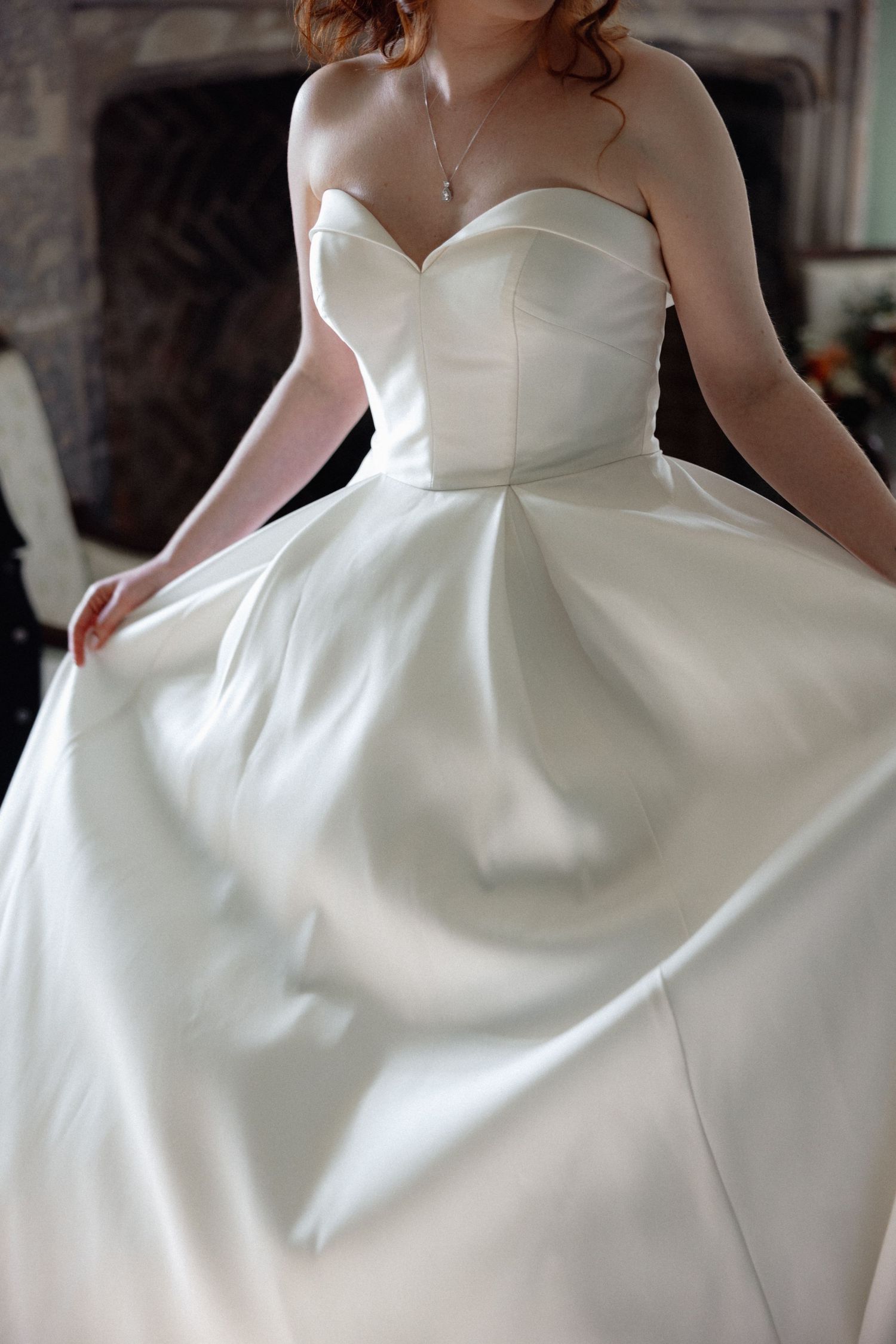 Close-up details of a structured white wedding gown with sweetheart neckline.