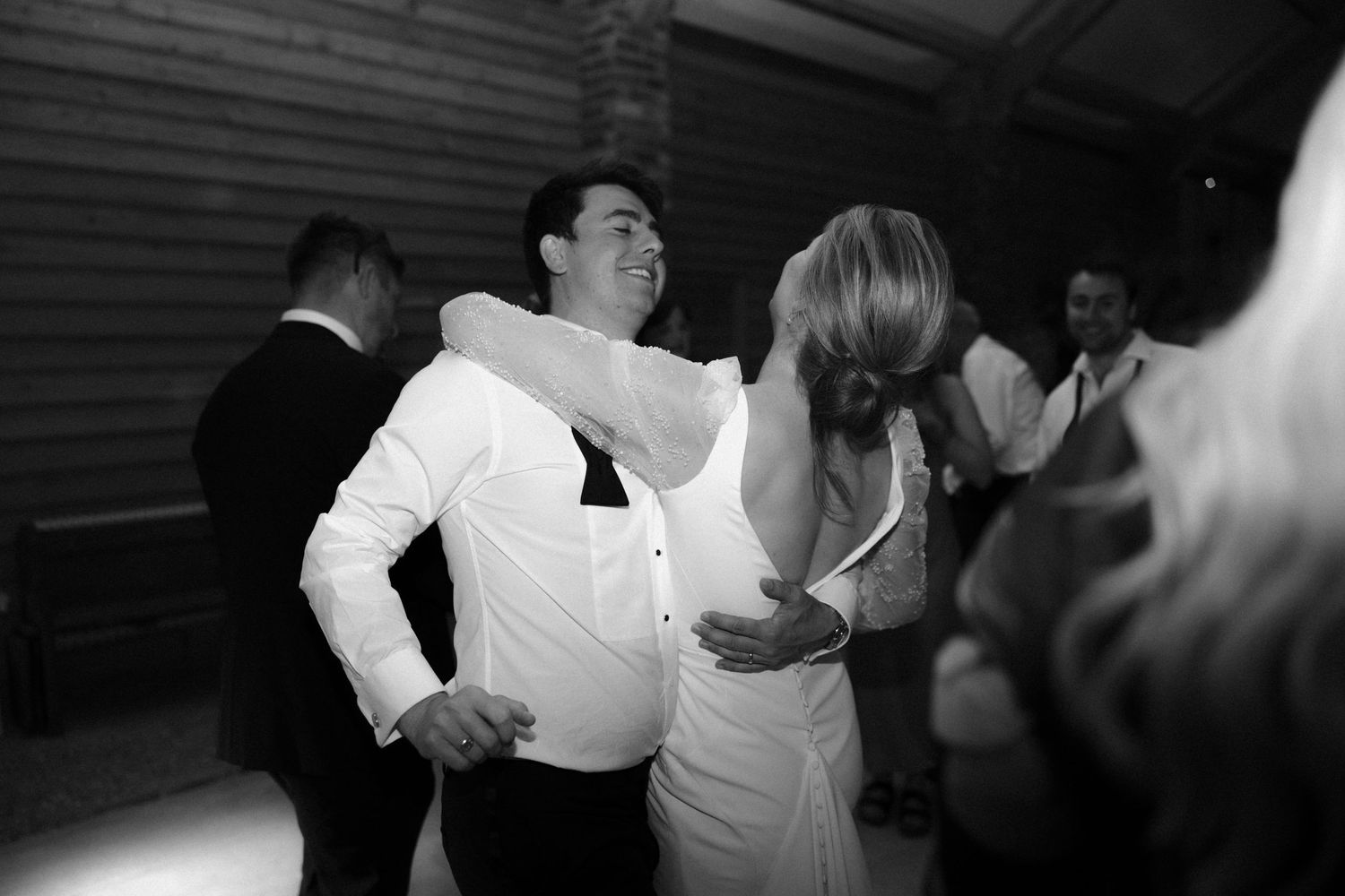 Guests enjoying a lively dance party at a wedding reception.