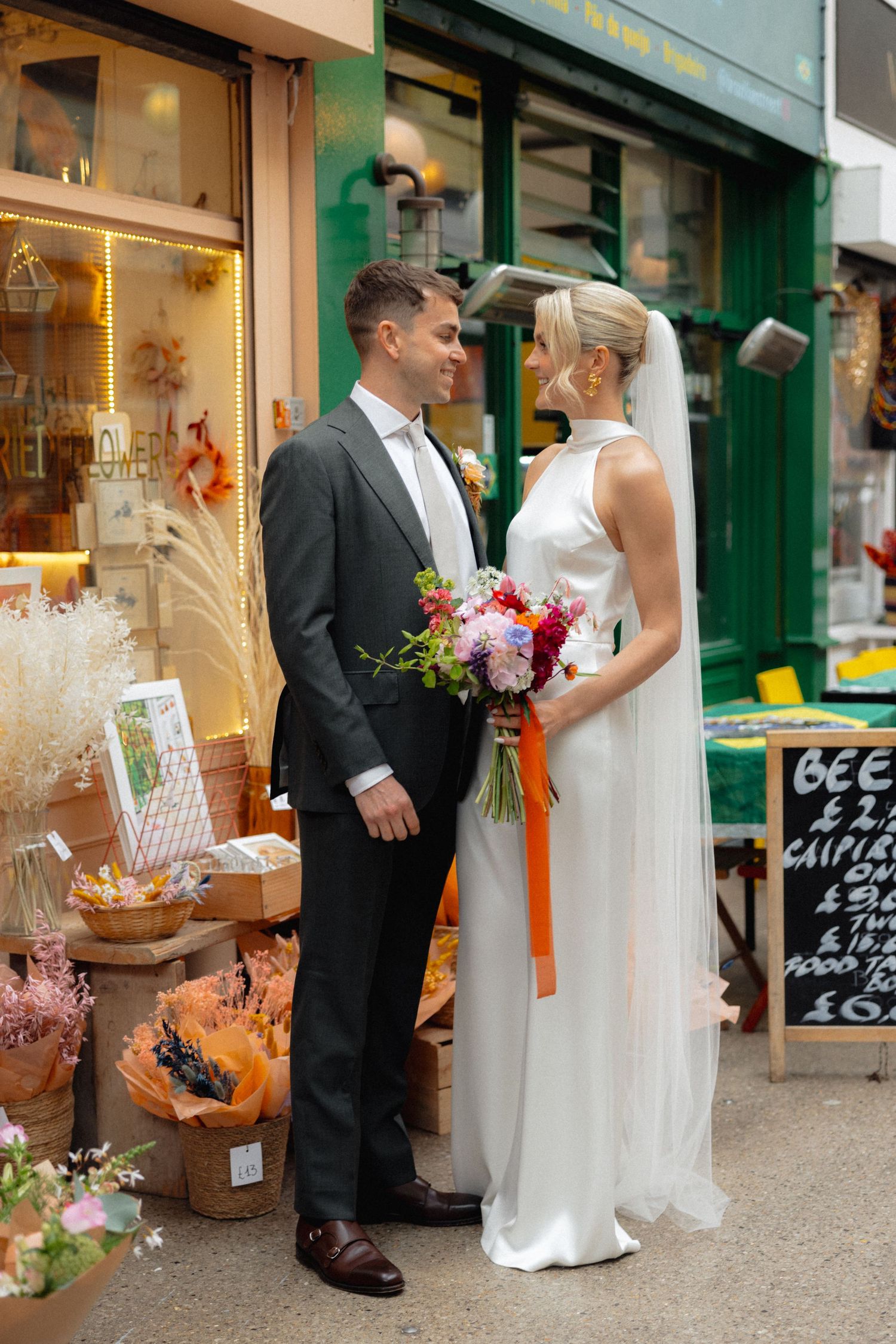 Wedding couple browsing local shops and storefronts on their special day.