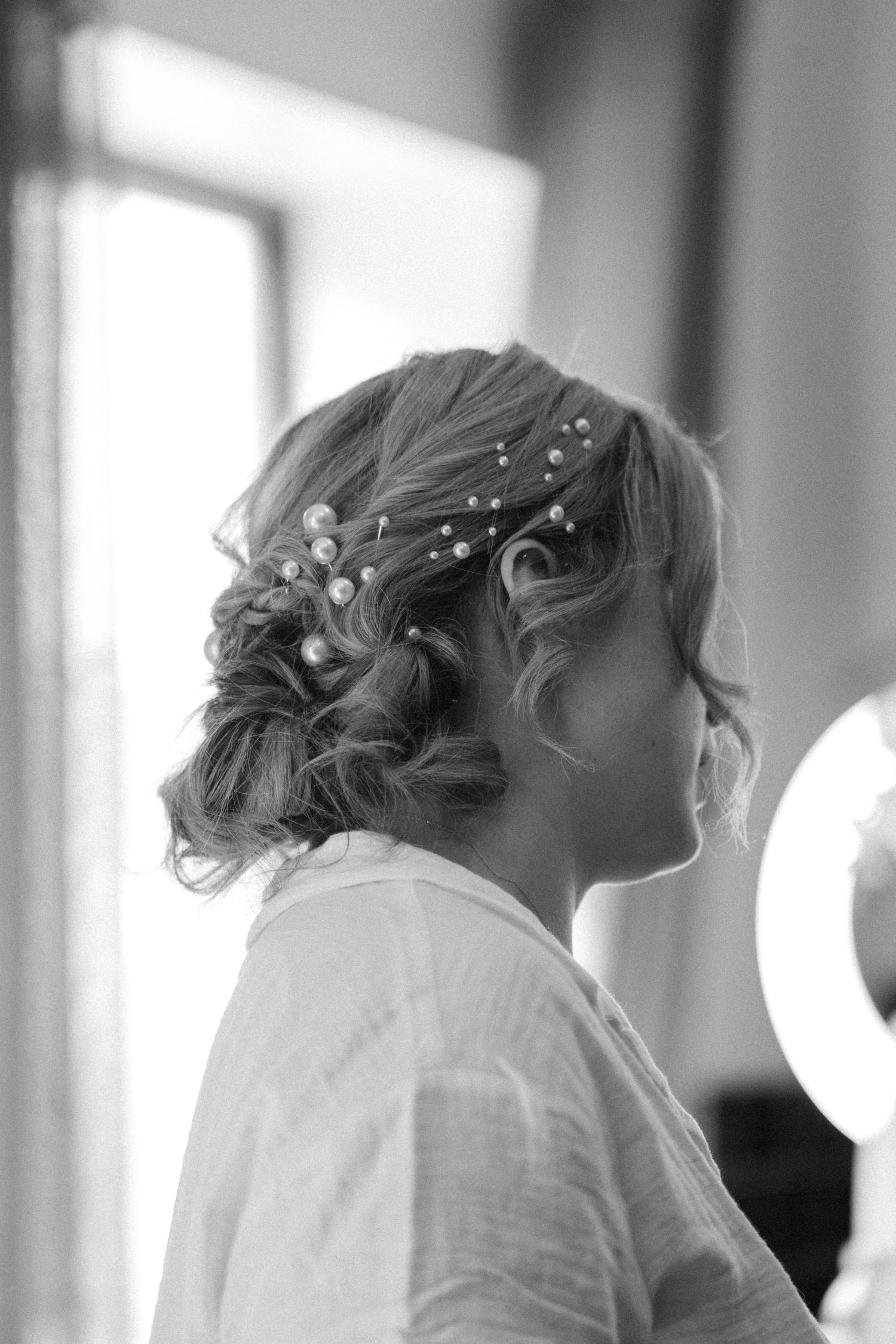 Soft focus black and white profile shots of wedding preparations.