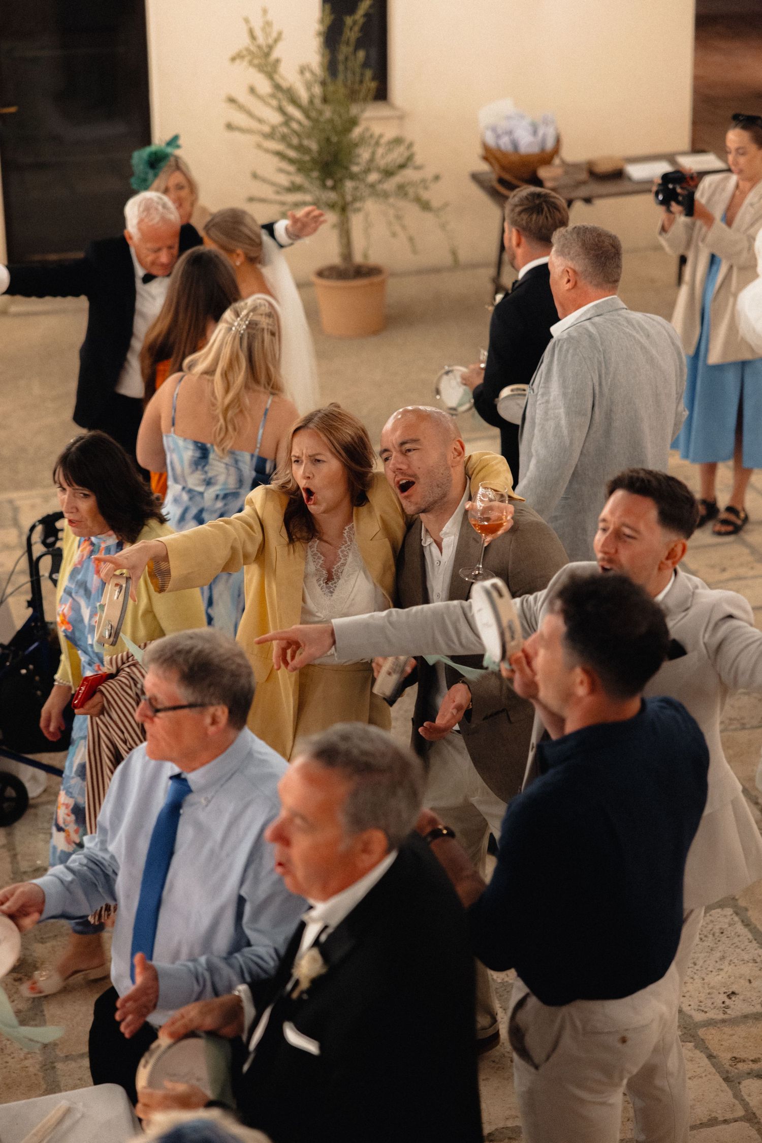 Wedding guests mingle and socialize during an outdoor cocktail reception.