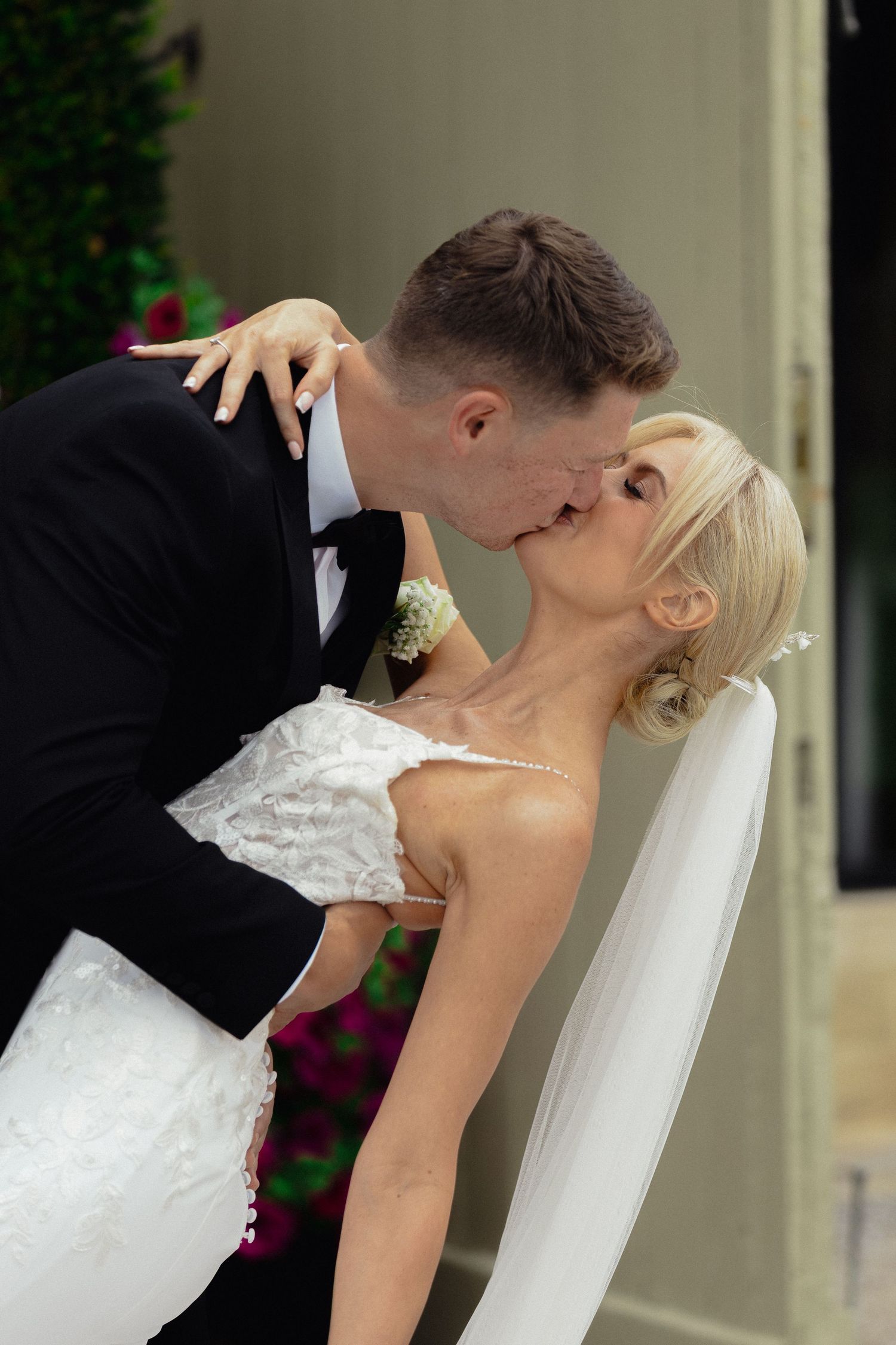 Romantic wedding couple sharing intimate moment during outdoor photo session.
