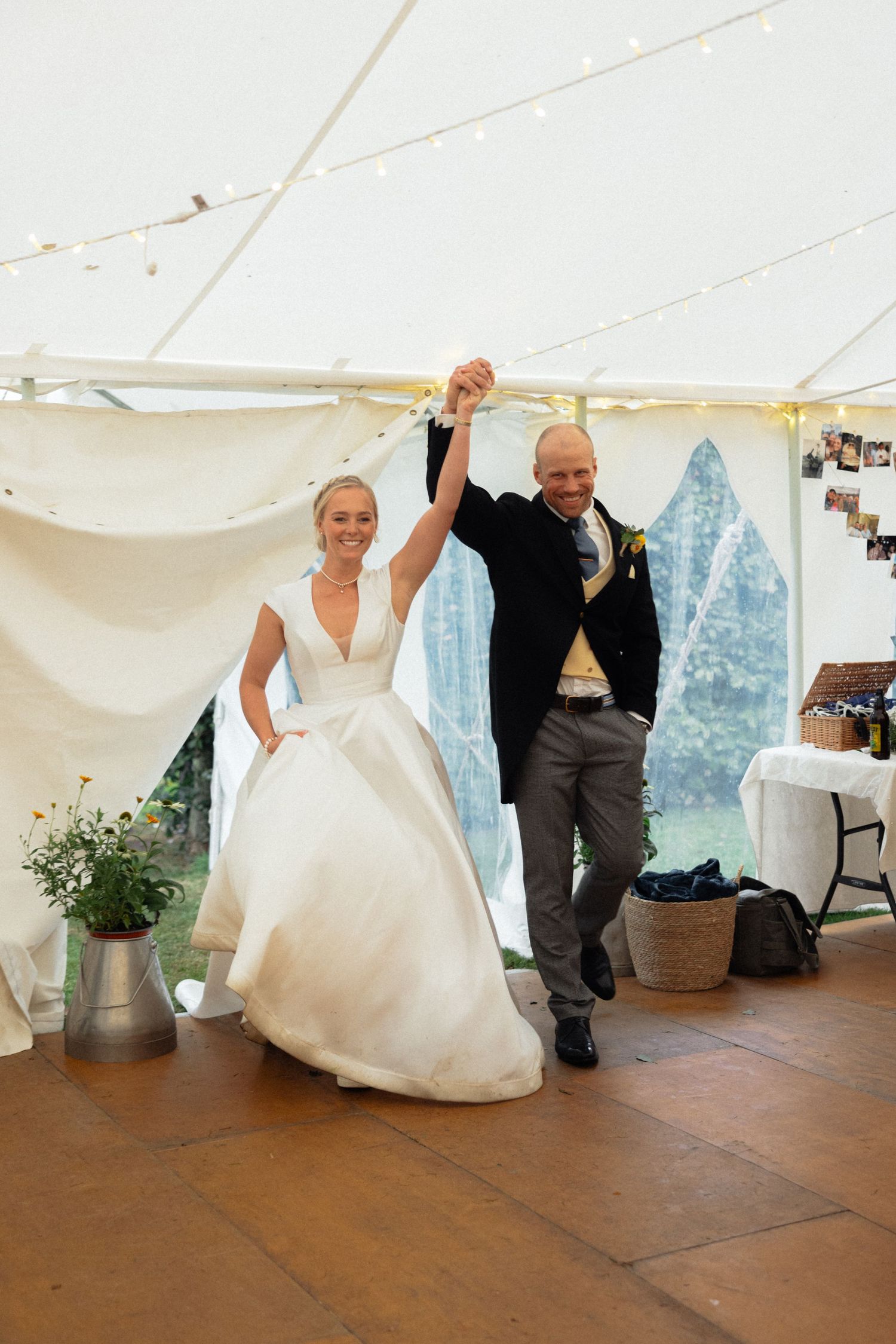 Dancing sequence in a wedding tent showing celebratory movements on the wooden floor.