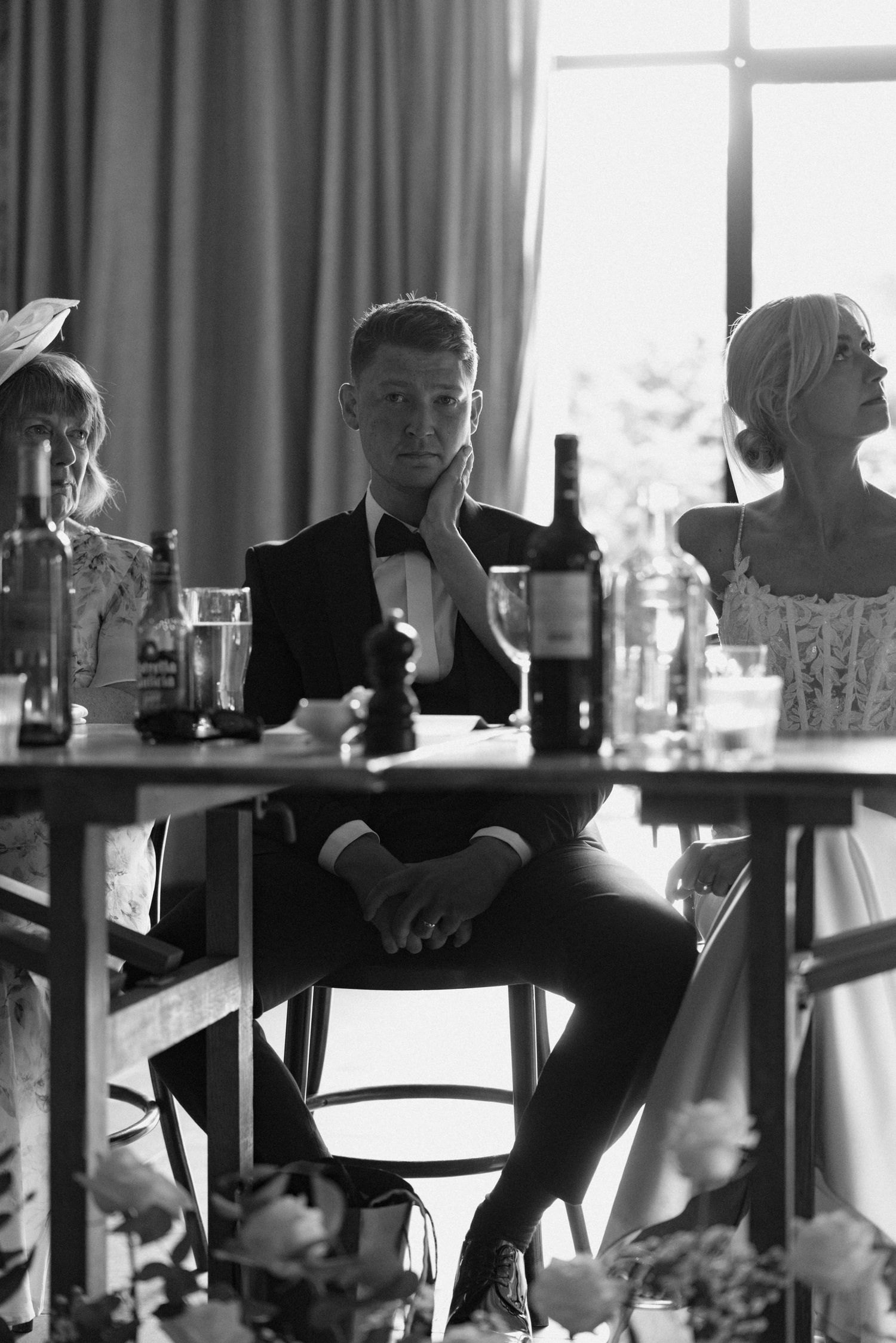 Silhouetted guests seated at tables during an elegant indoor reception.
