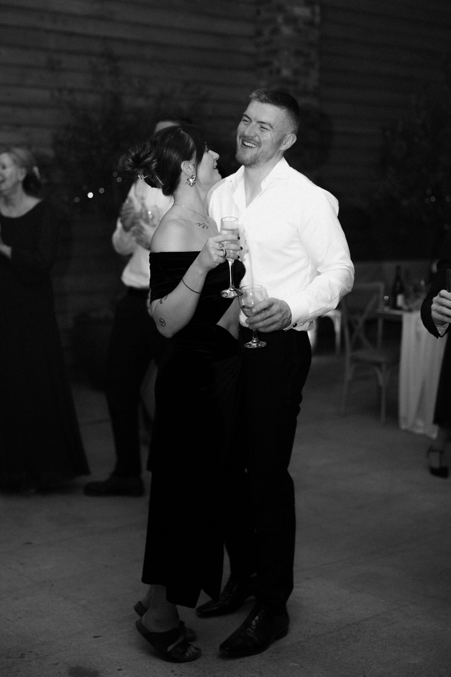 Wedding reception guests dancing and mingling on the dance floor.