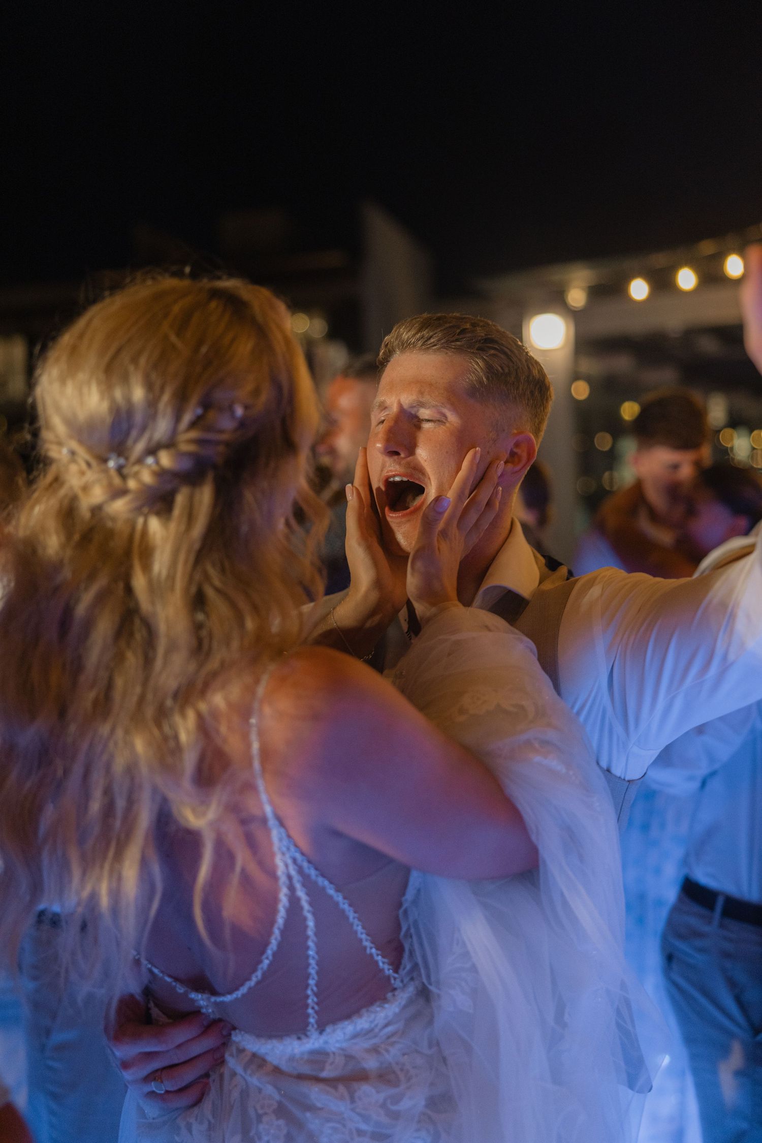 Energetic dancing and celebration captured during lively wedding reception party.