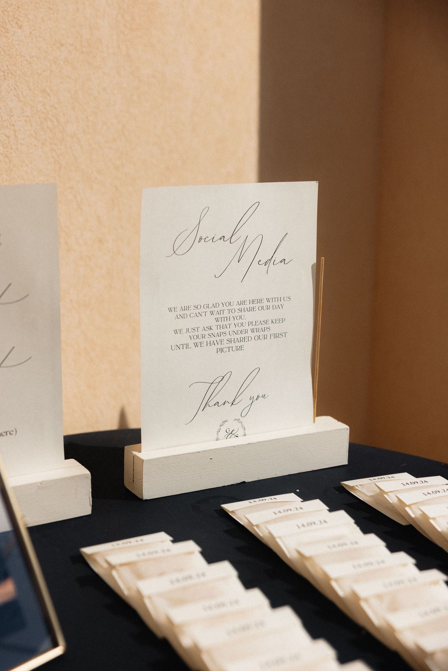 Elegant white place cards arranged on black tablecloth at formal event.