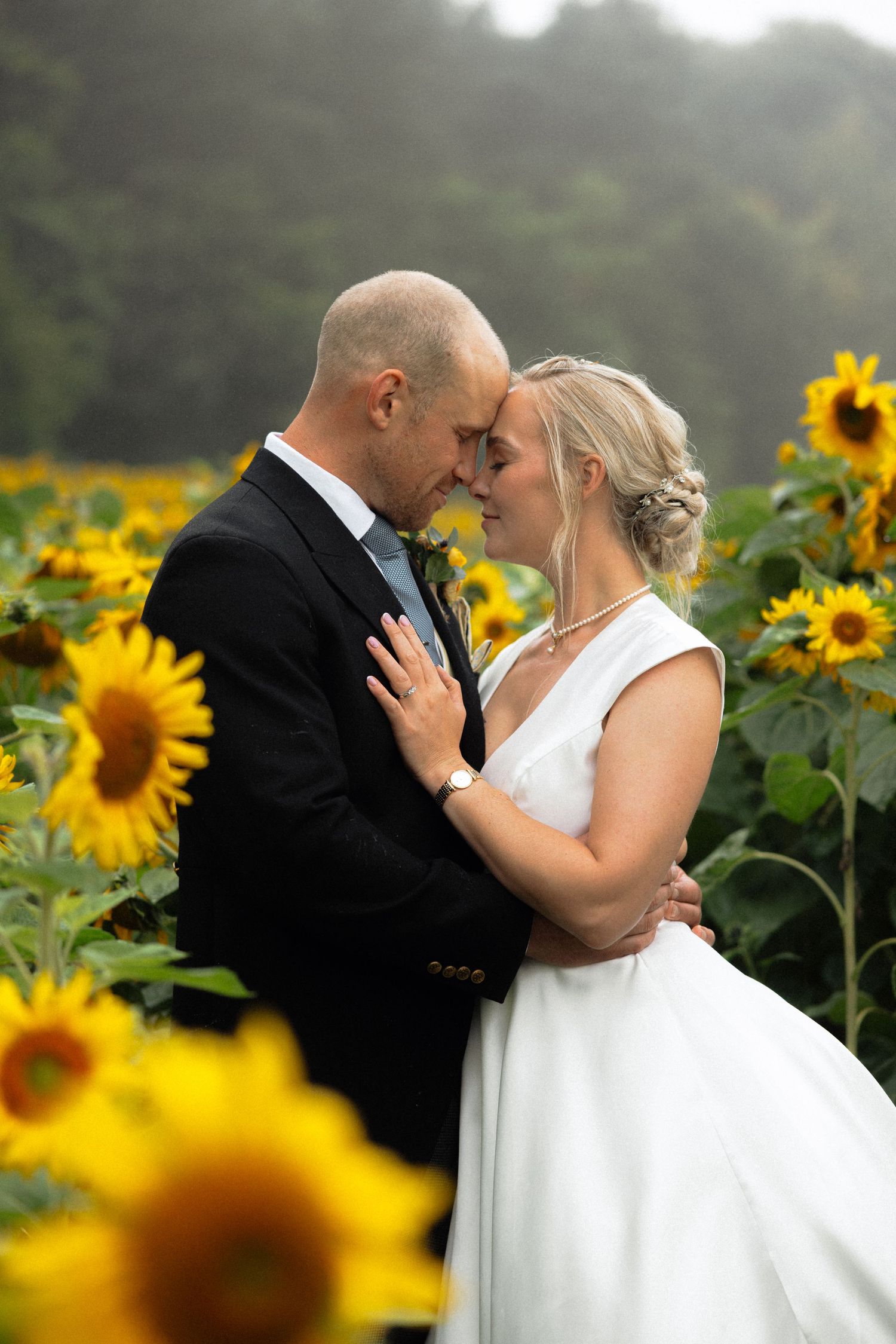 Intimate wedding portraits captured in sequence with sunflowers and natural lighting.