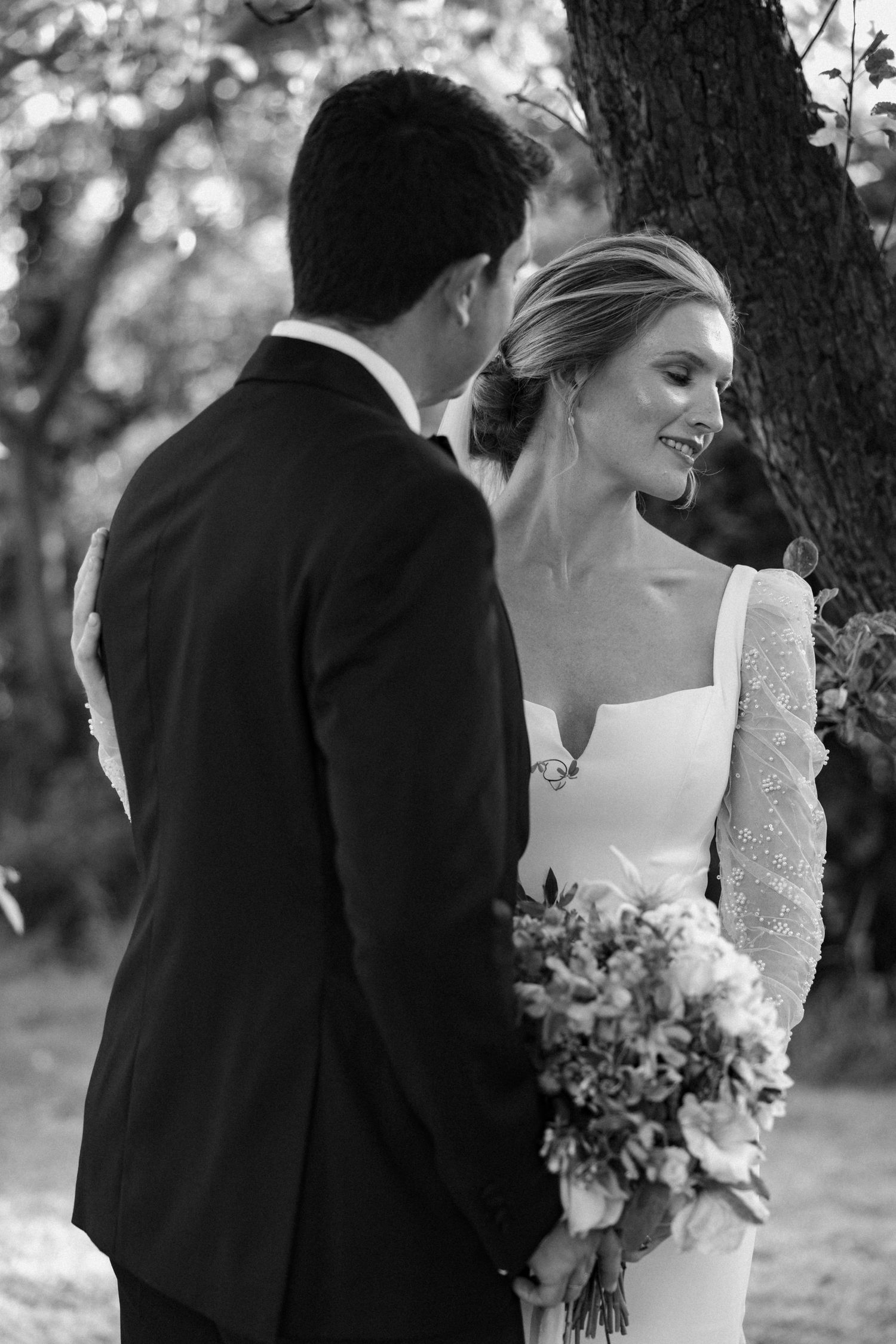 Black and white romantic wedding portraits in a natural outdoor setting.