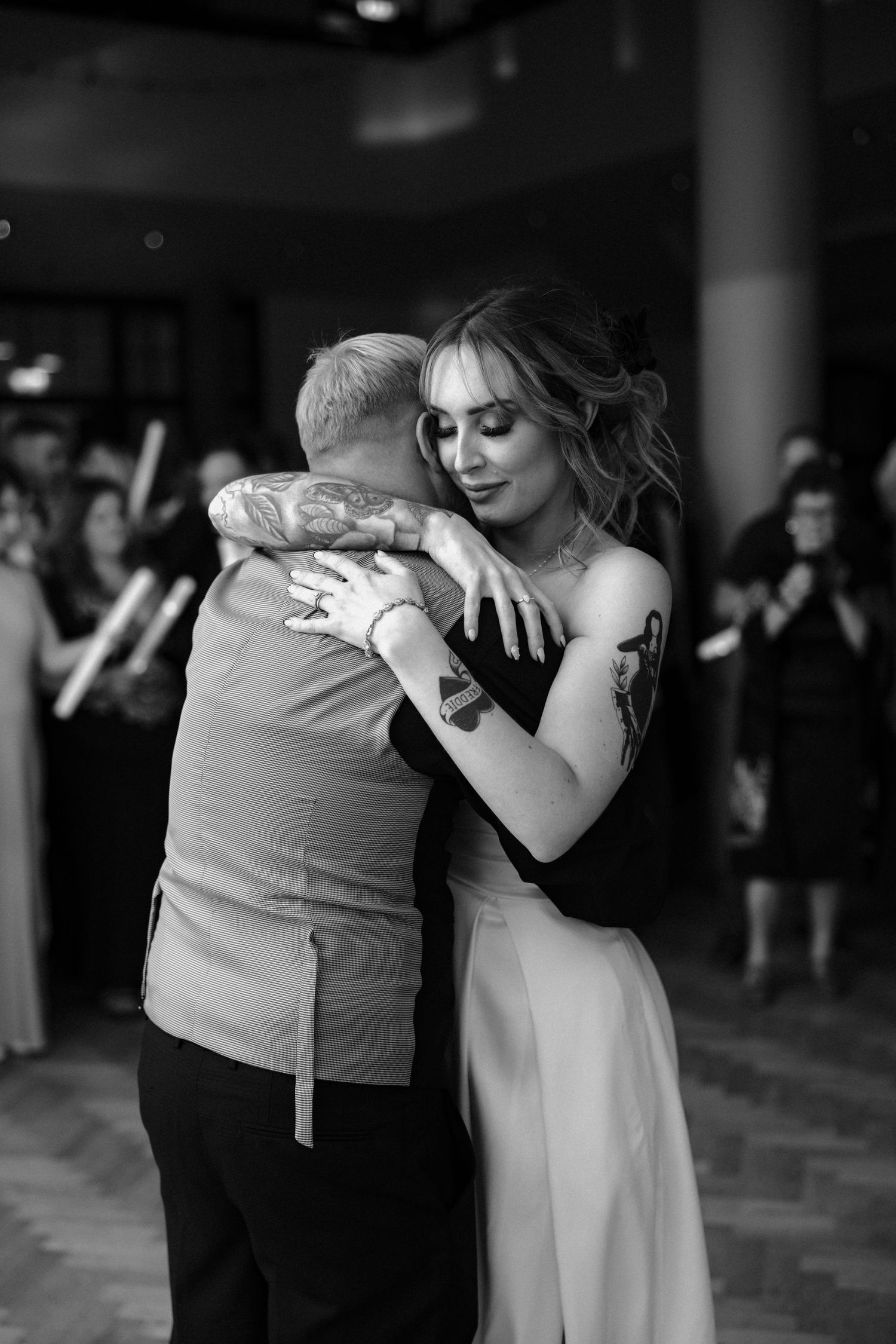 A couple shares an intimate dance moment at their wedding reception.
