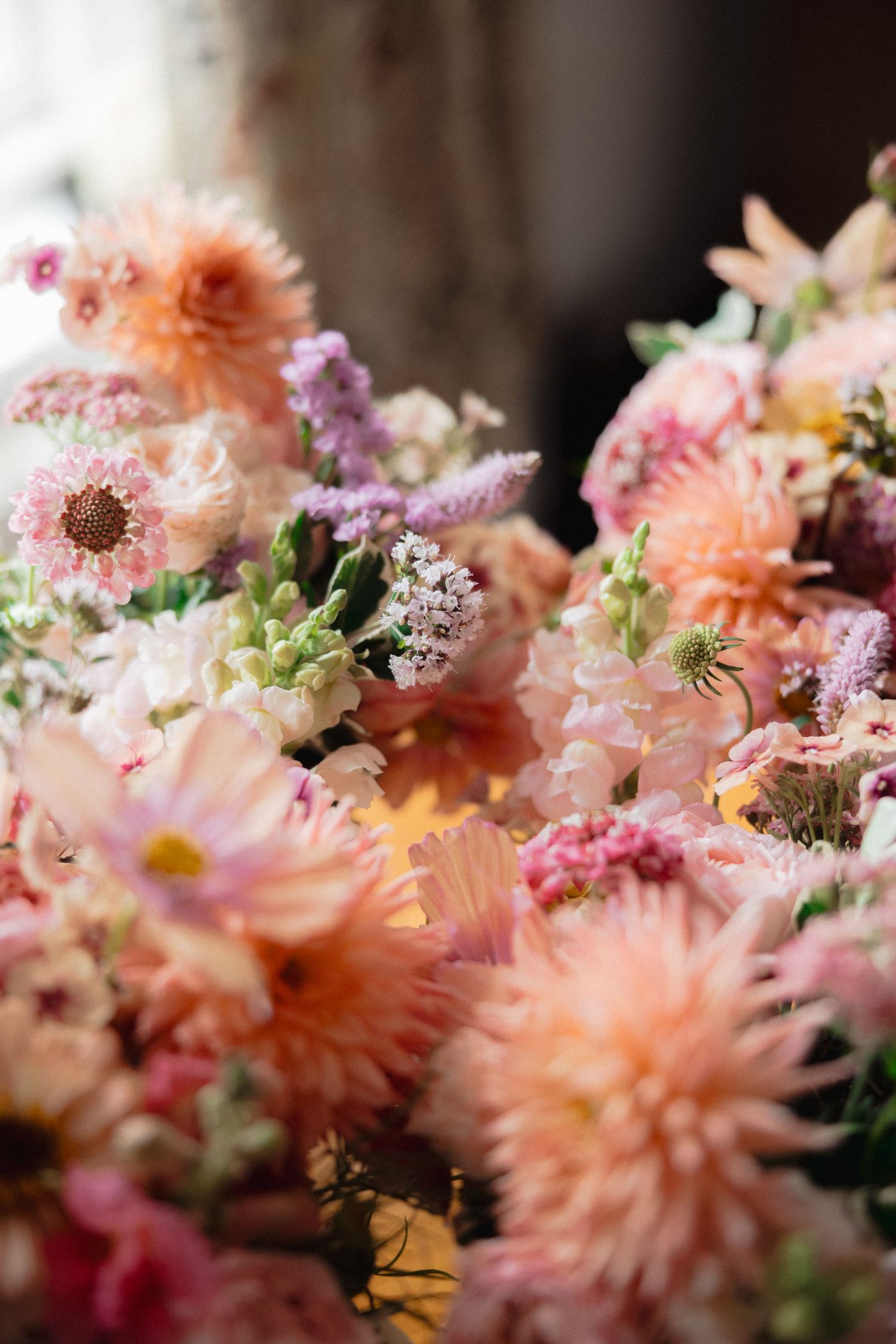 Close-up of delicate peach and pink floral arrangements with soft focus detail.