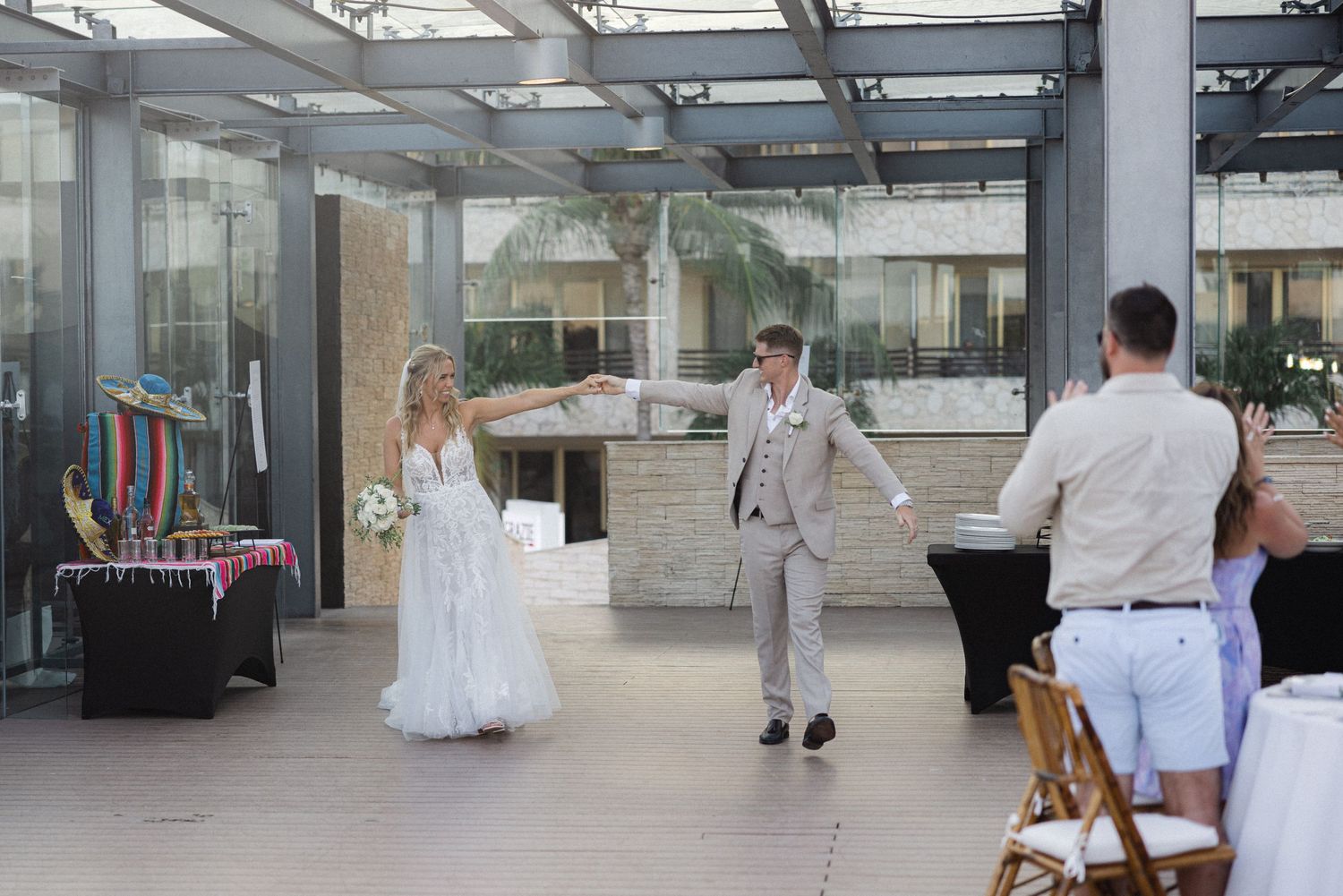 Wedding reception venue with white decor and glass ceiling showing natural light.