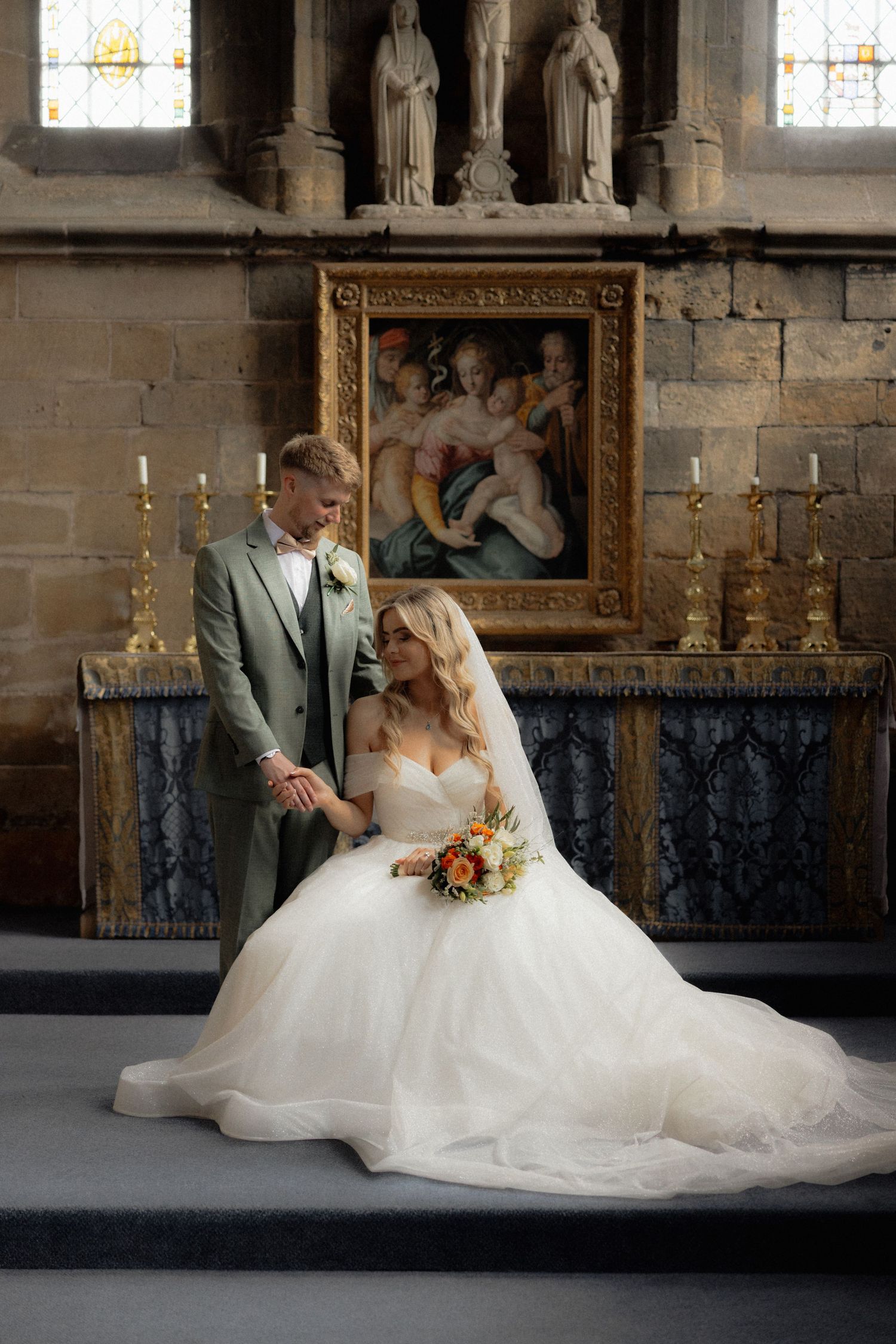 A romantic wedding photo shoot inside a historic church with stained glass windows.