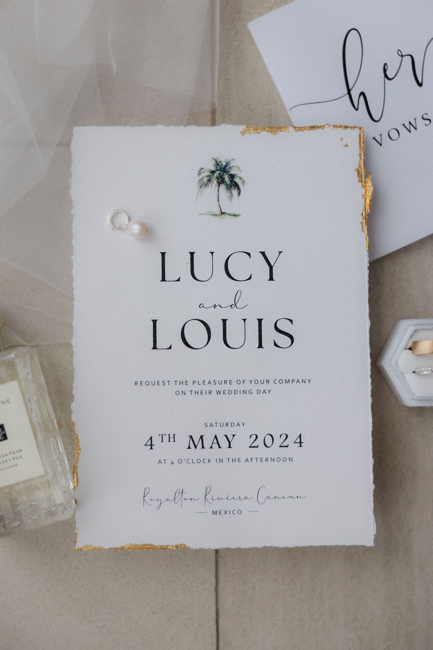 Wedding invitation for Lucy and Louis featuring minimalist typography and gold accents.