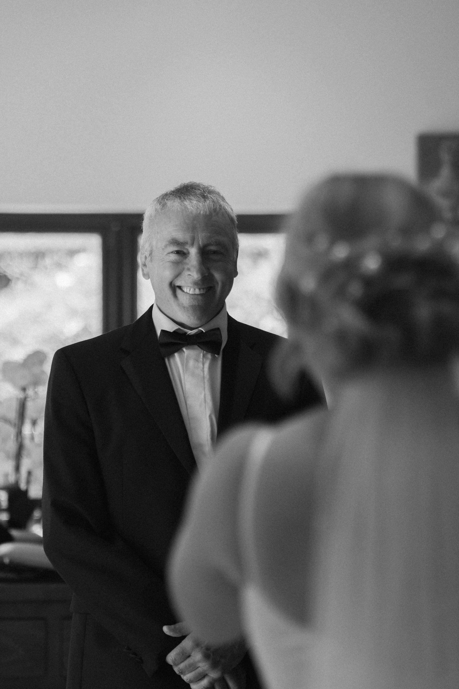 Black and white candid moments before a formal wedding ceremony.