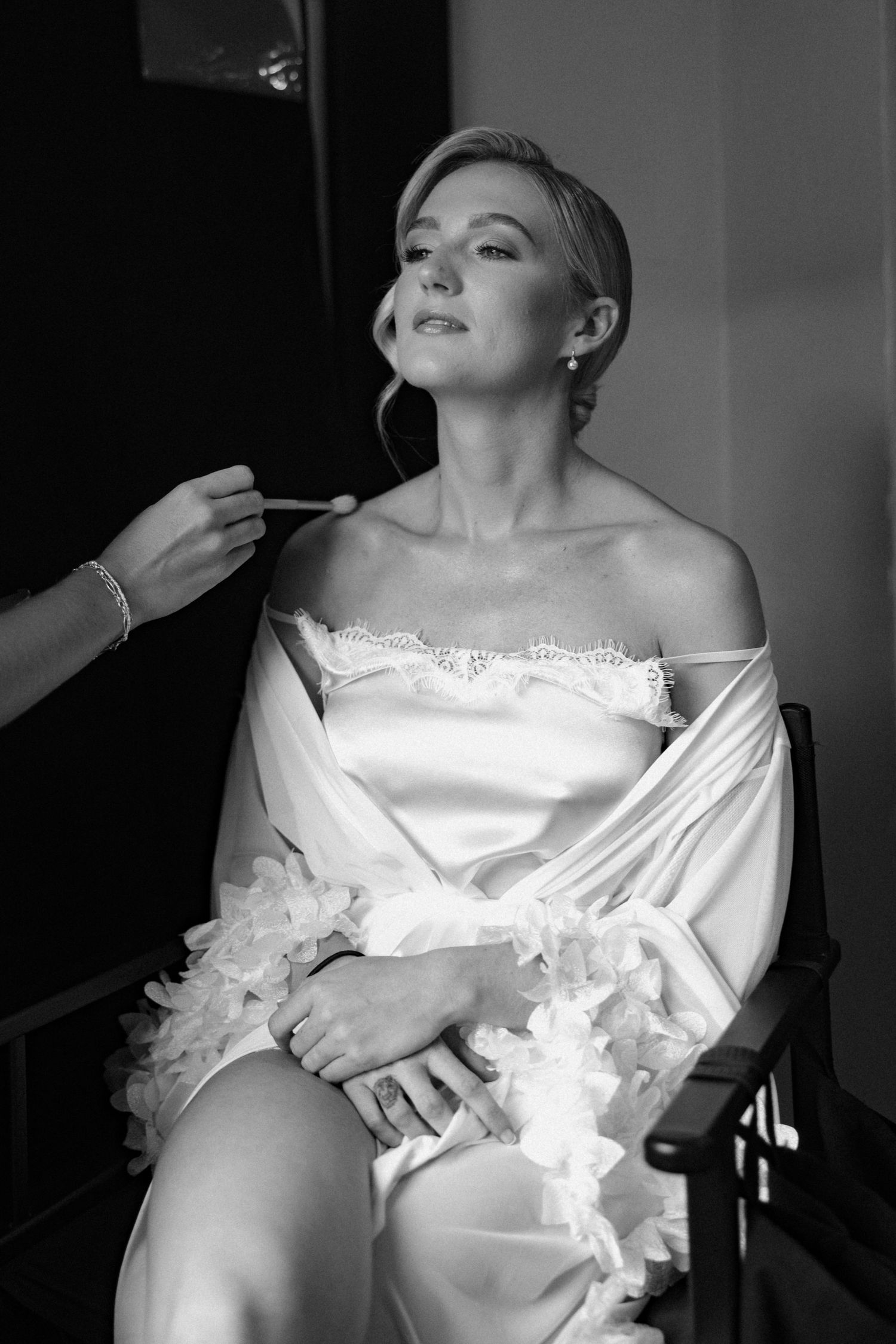 Artistic black and white bridal portrait series showing elegant white wedding attire.